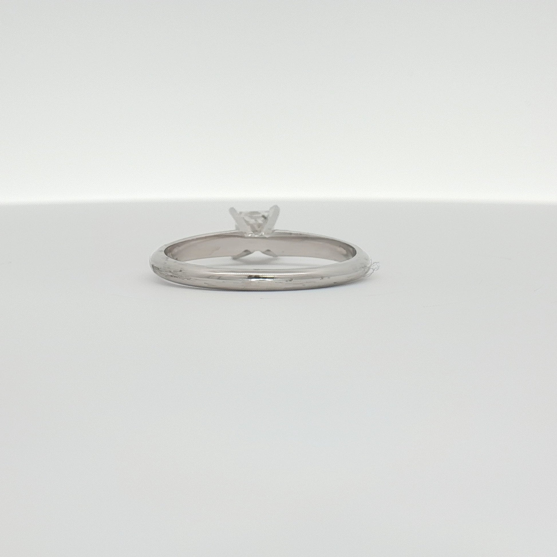 14K white gold diamond solitaire engagement ring showing a central round brilliant diamond set in a sleek white gold band.