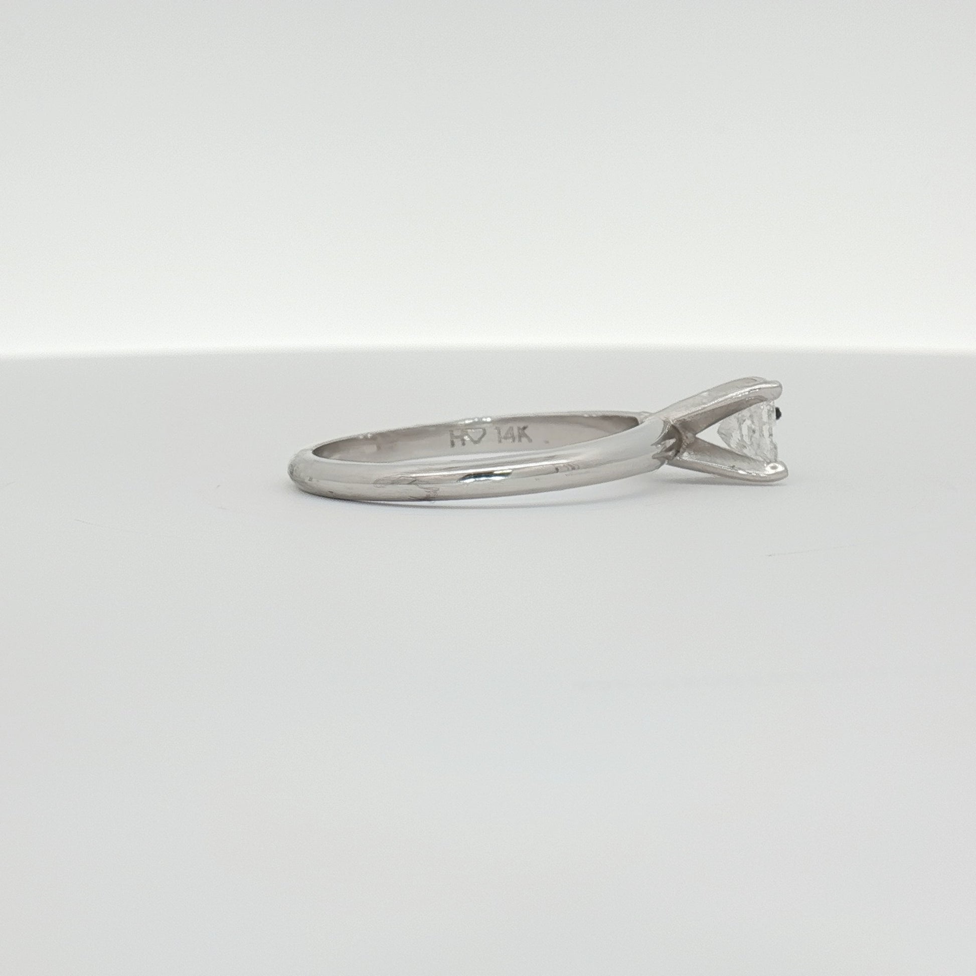 14K white gold diamond solitaire engagement ring with a round center stone, elegant jewelry design by Gold & Beyond.