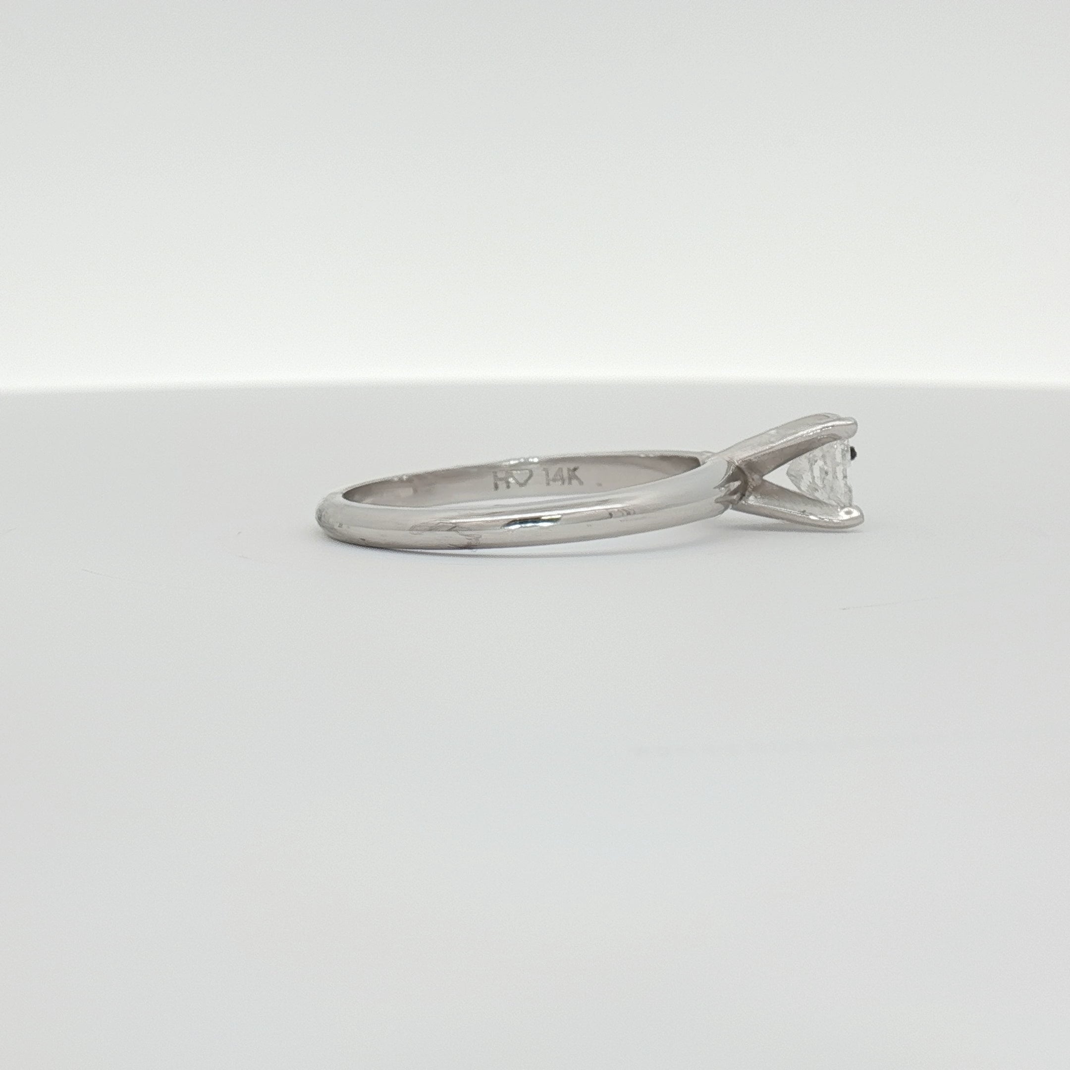 14K white gold diamond solitaire engagement ring with a round center stone, elegant jewelry design by Gold & Beyond.