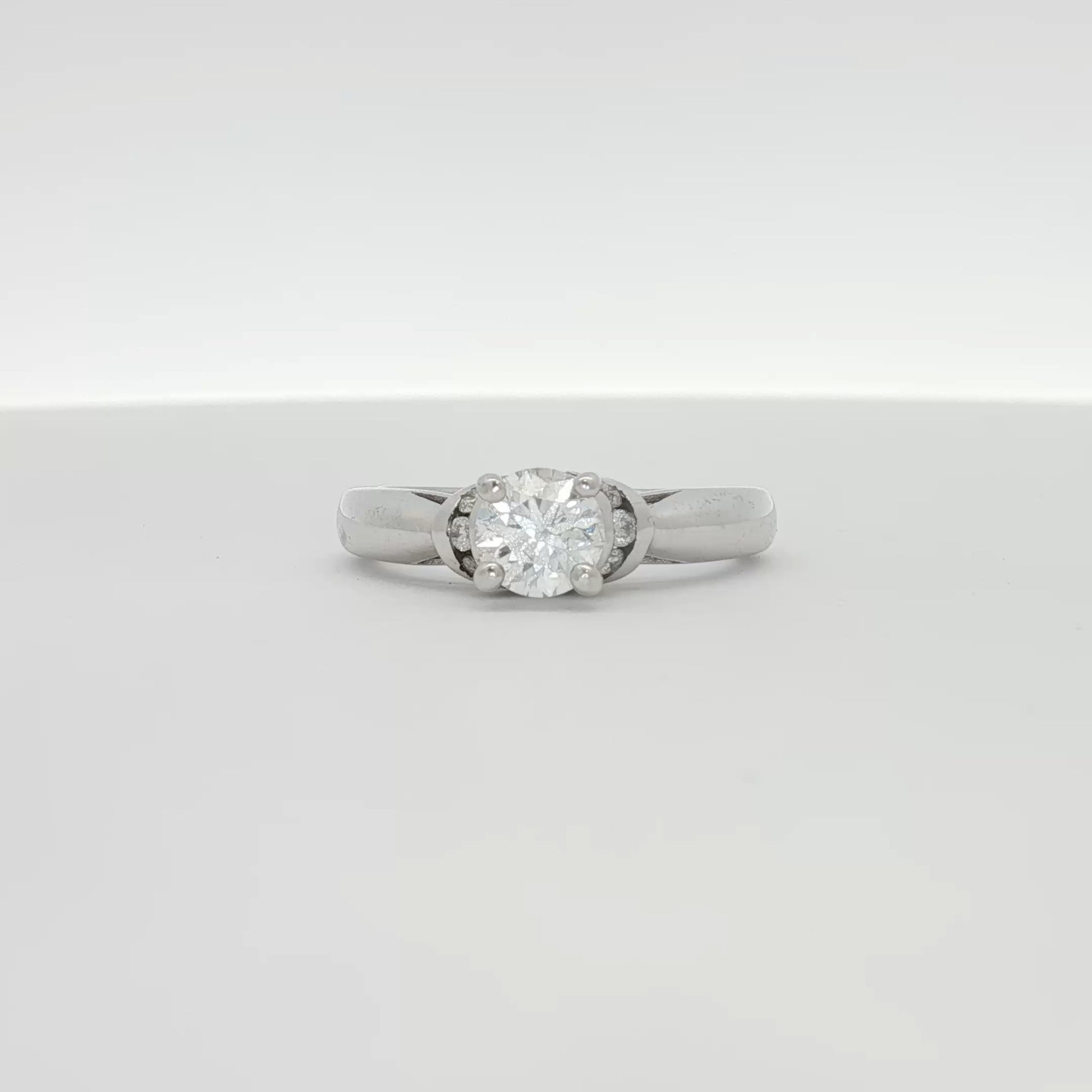 14K white gold diamond solitaire engagement ring with a sparkling round center diamond and a sleek band, by Gold & Beyond.