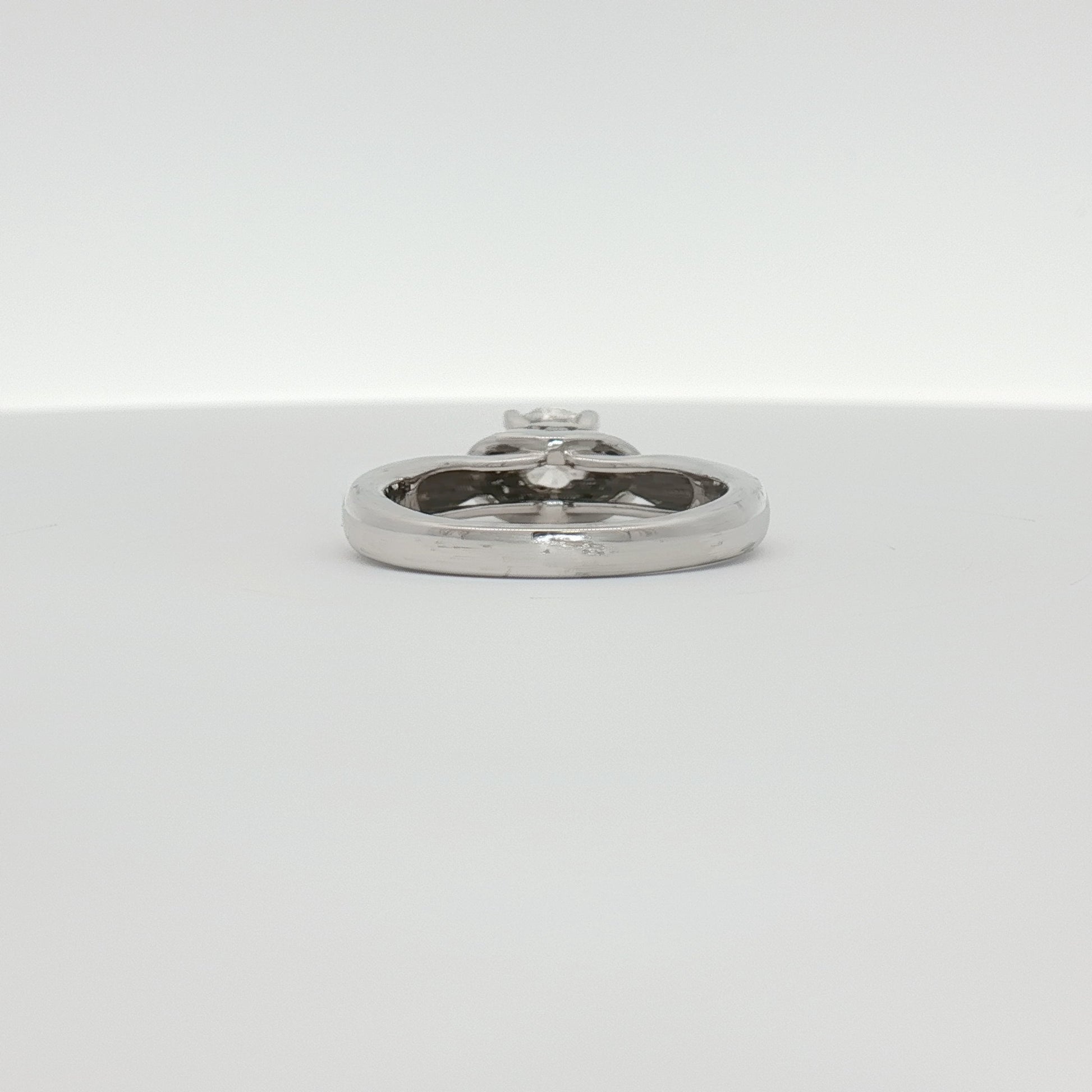 14K white gold diamond solitaire engagement ring featuring a sparkling central diamond and a sleek, elegant band.