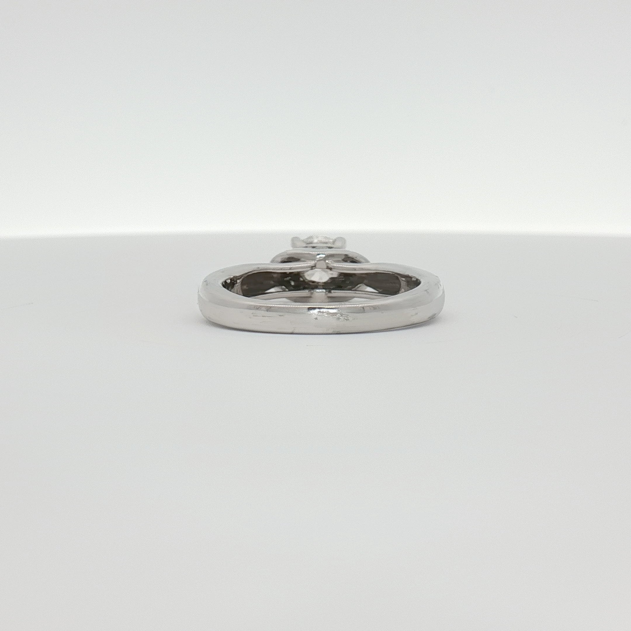 14K white gold diamond solitaire engagement ring featuring a sparkling central diamond and a sleek, elegant band.