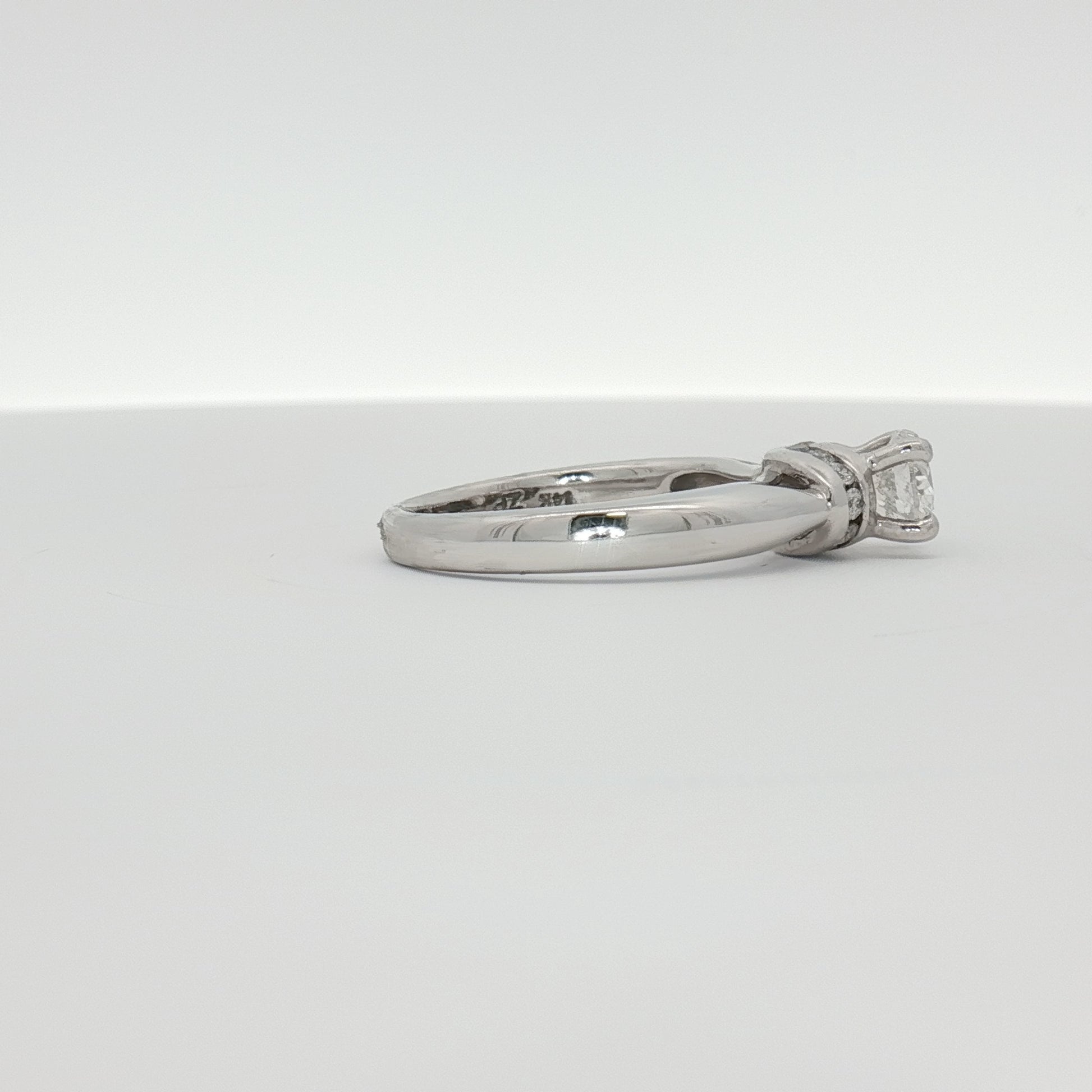 14K white gold diamond solitaire engagement ring with a central round diamond, elegant jewelry piece by Gold & Beyond.