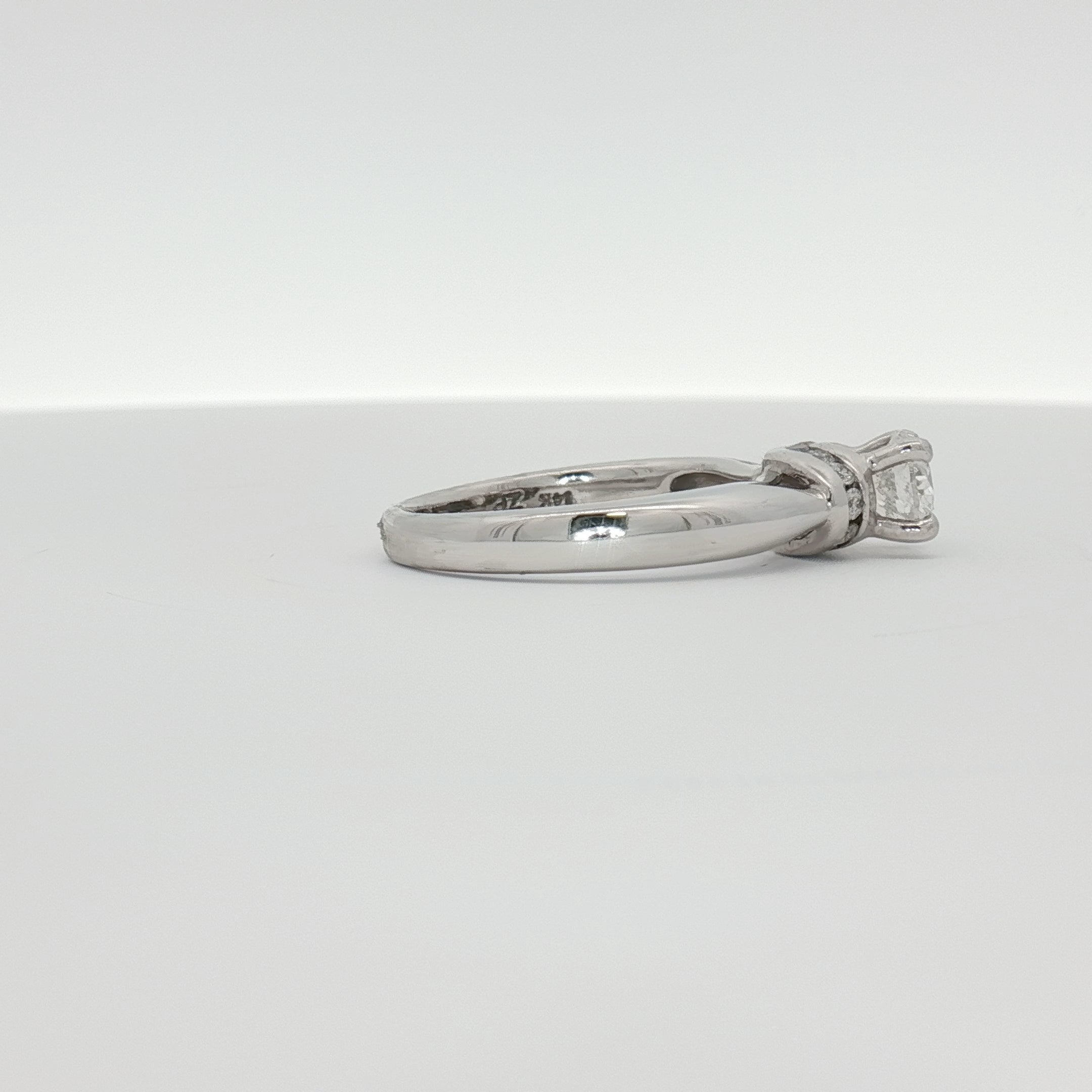 14K white gold diamond solitaire engagement ring with a central round diamond, elegant jewelry piece by Gold & Beyond.