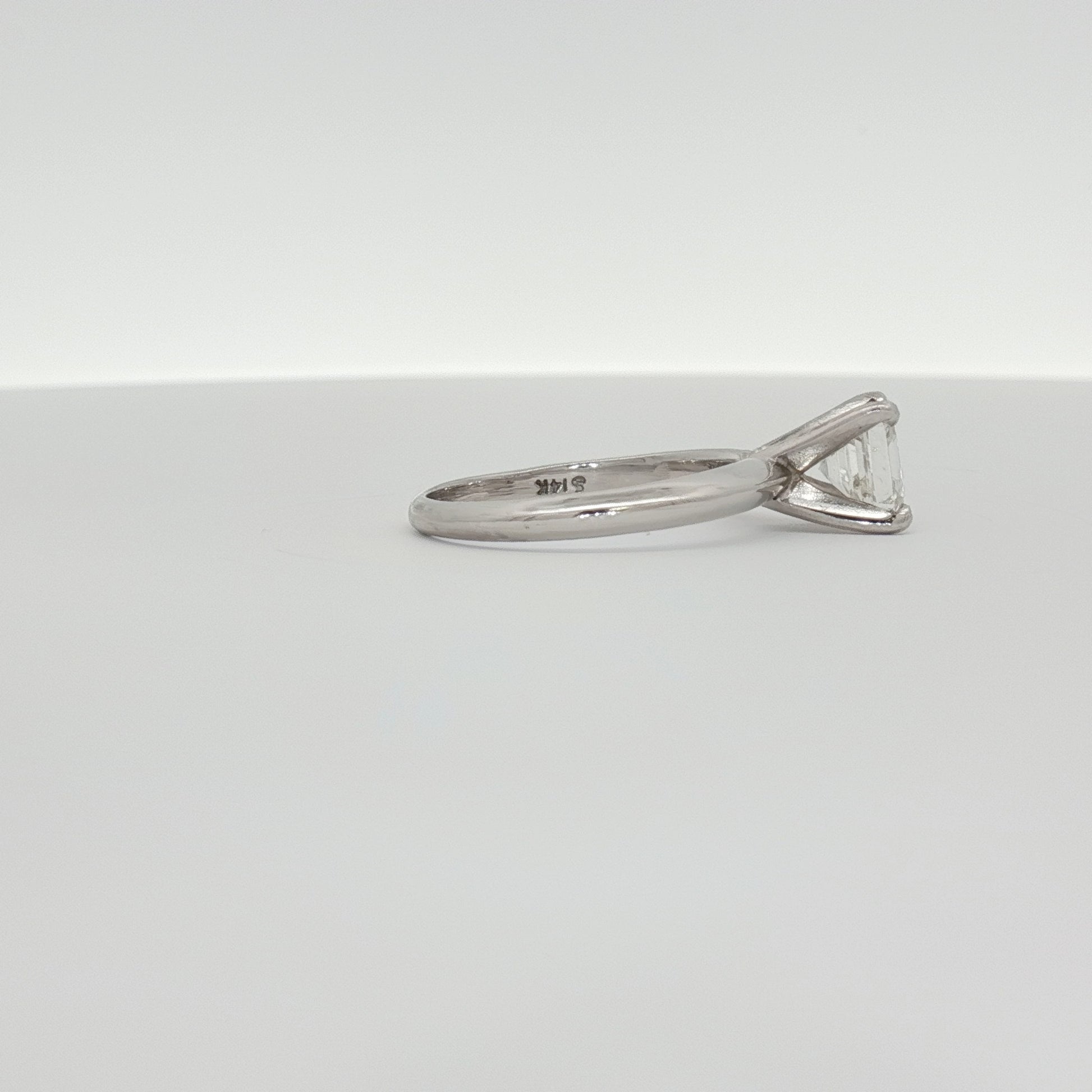 14K white gold diamond solitaire engagement ring with a sparkling center stone, crafted by Gold & Beyond.