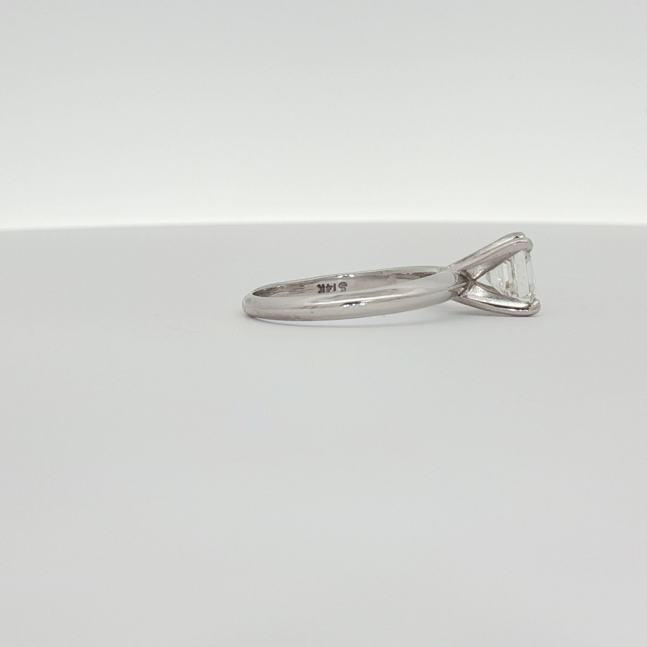 14K white gold diamond solitaire engagement ring with a sparkling center stone, crafted by Gold & Beyond.