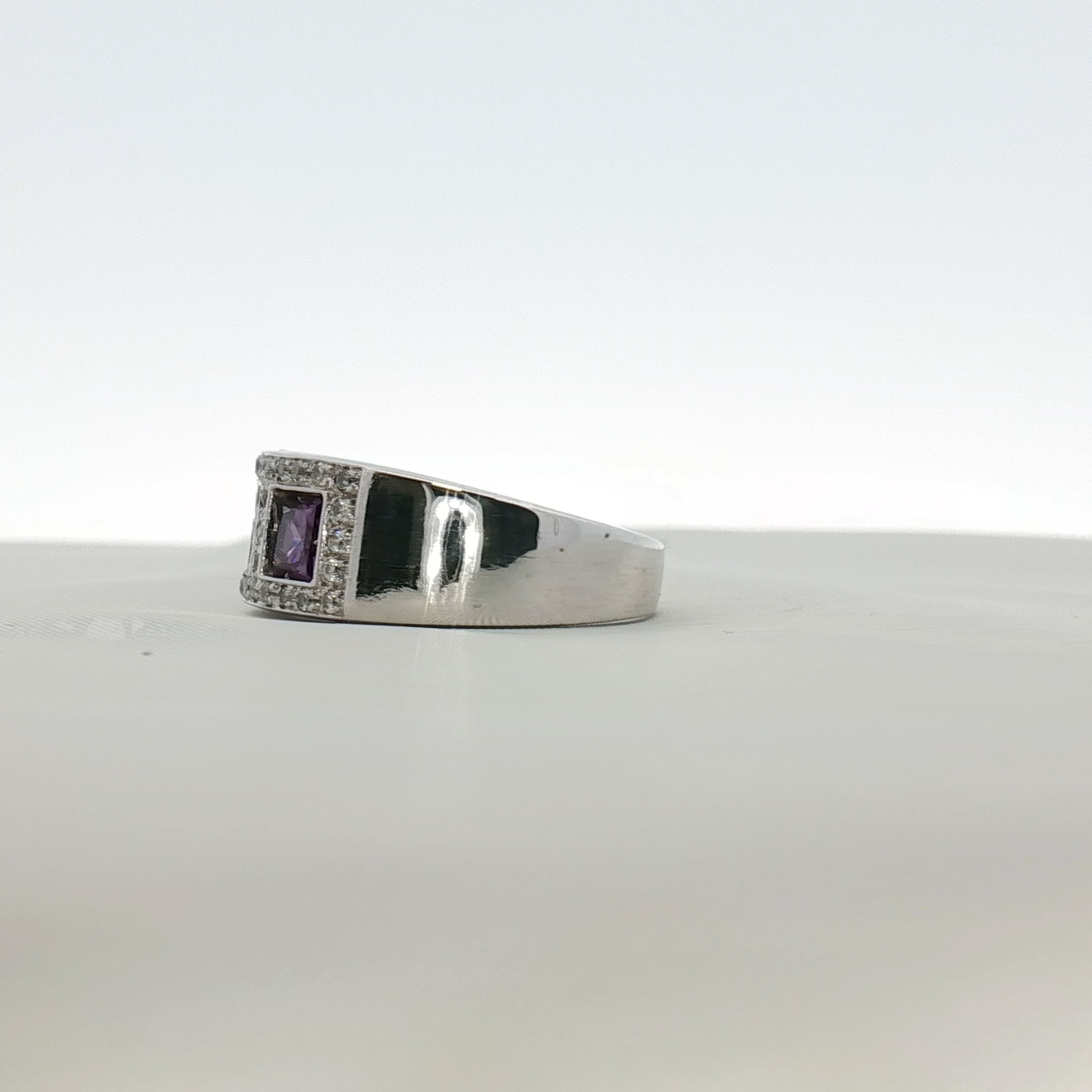 Three-stone diamond and purple gemstone ring by Gold & Beyond, showcasing sparkling diamonds and vibrant purple stones in elegant jewelry.