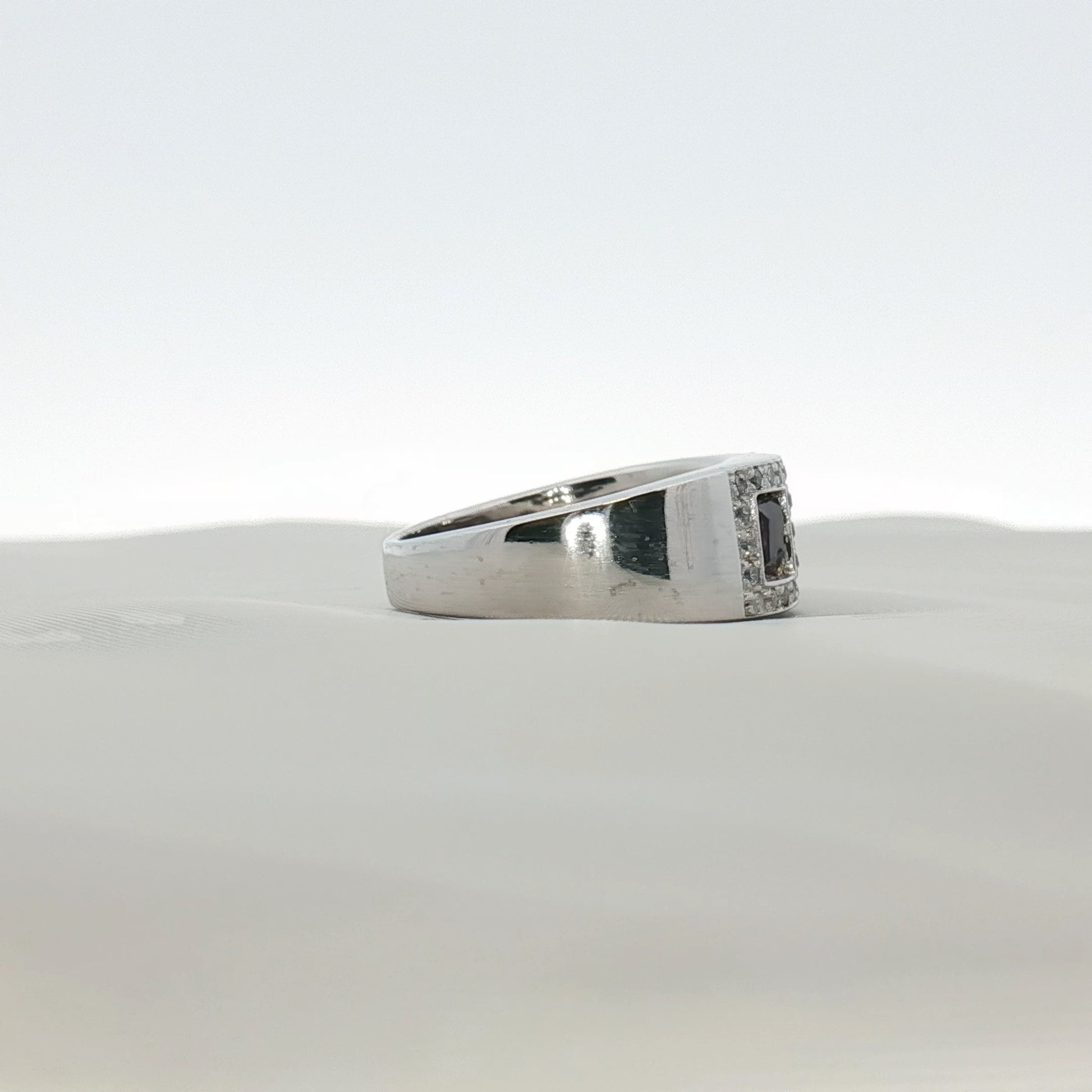 Three-stone gold ring featuring diamonds and purple gemstones, showcasing elegant jewelry design by Gold & Beyond.