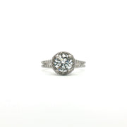 Platinum diamond halo ring with sparkling center stone and surrounding smaller diamonds, crafted by Gold & Beyond.