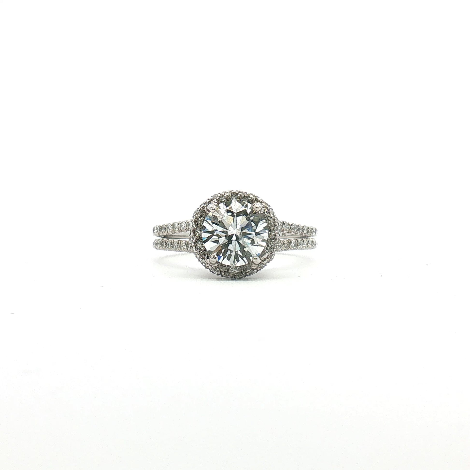 Platinum diamond halo ring with sparkling center stone and surrounding smaller diamonds, crafted by Gold & Beyond.