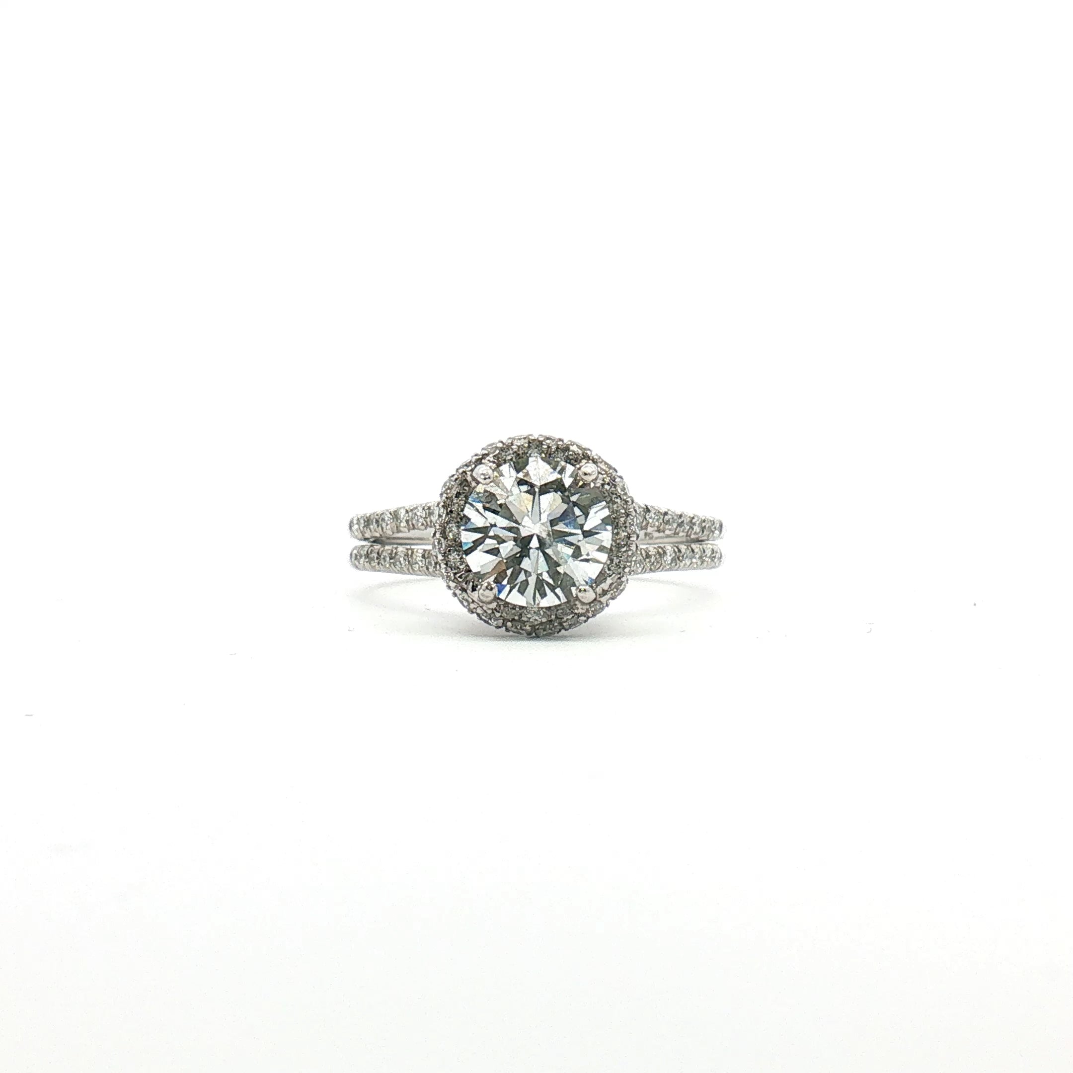 Platinum diamond halo ring with sparkling center stone and surrounding smaller diamonds, crafted by Gold & Beyond.