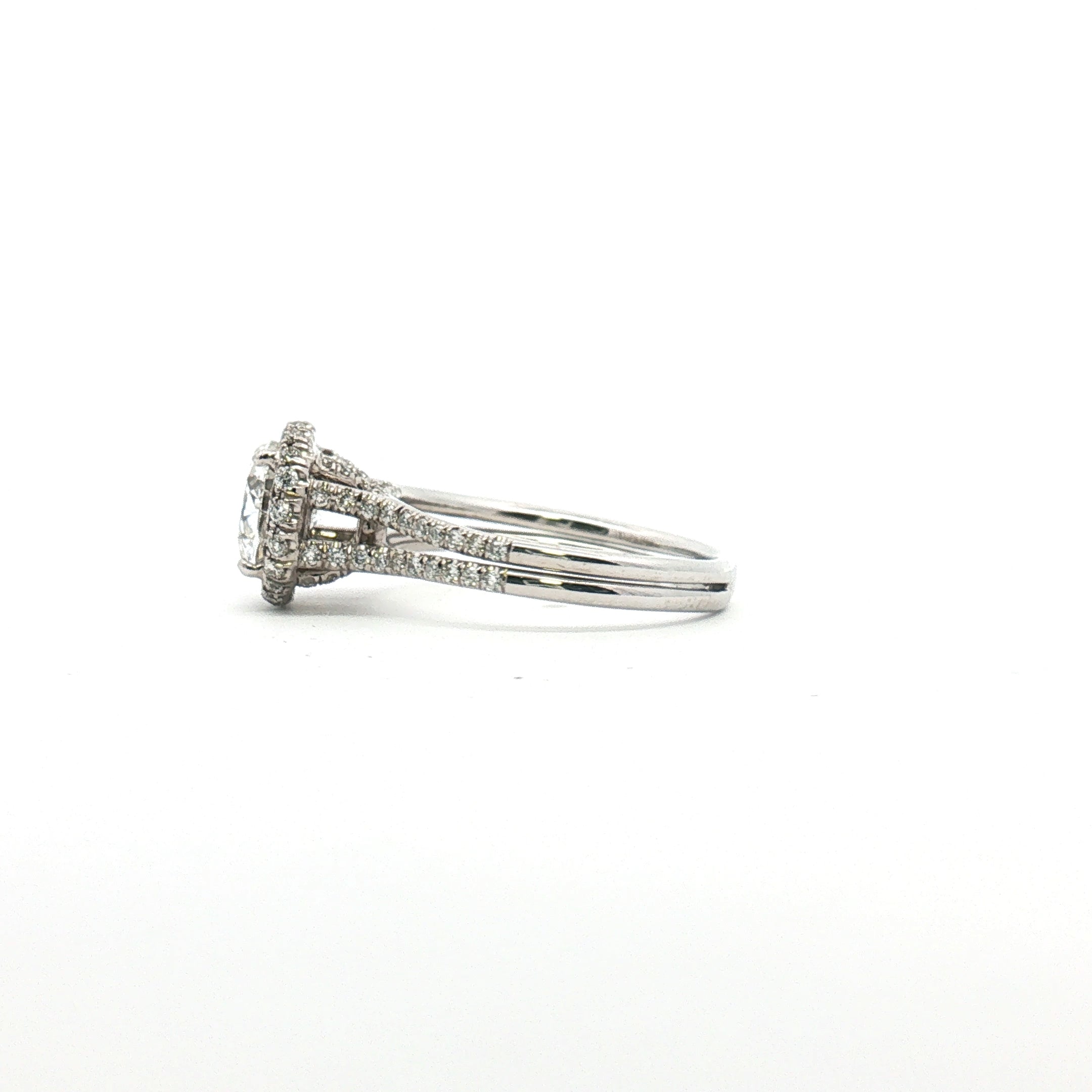 Platinum diamond halo ring with central diamond surrounded by smaller diamonds, elegant jewelry piece from Gold & Beyond.