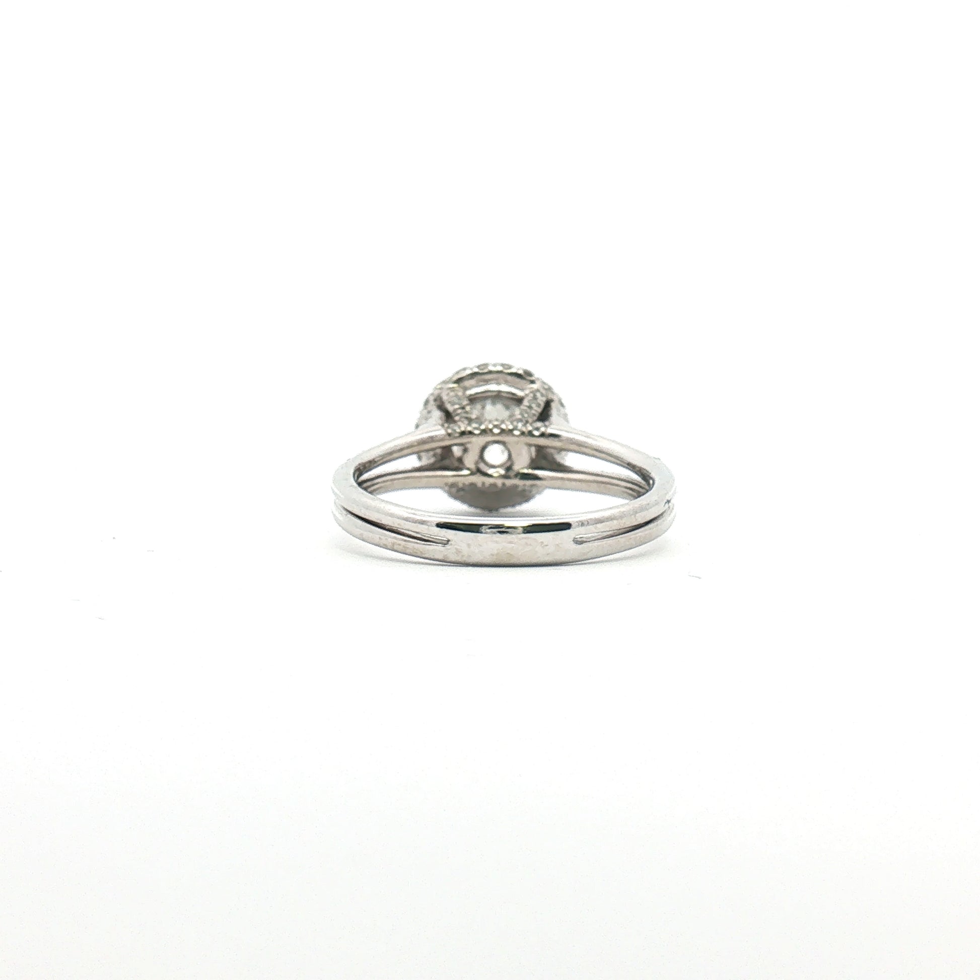 Platinum diamond halo ring with a central gemstone surrounded by smaller diamonds, crafted by Gold & Beyond.