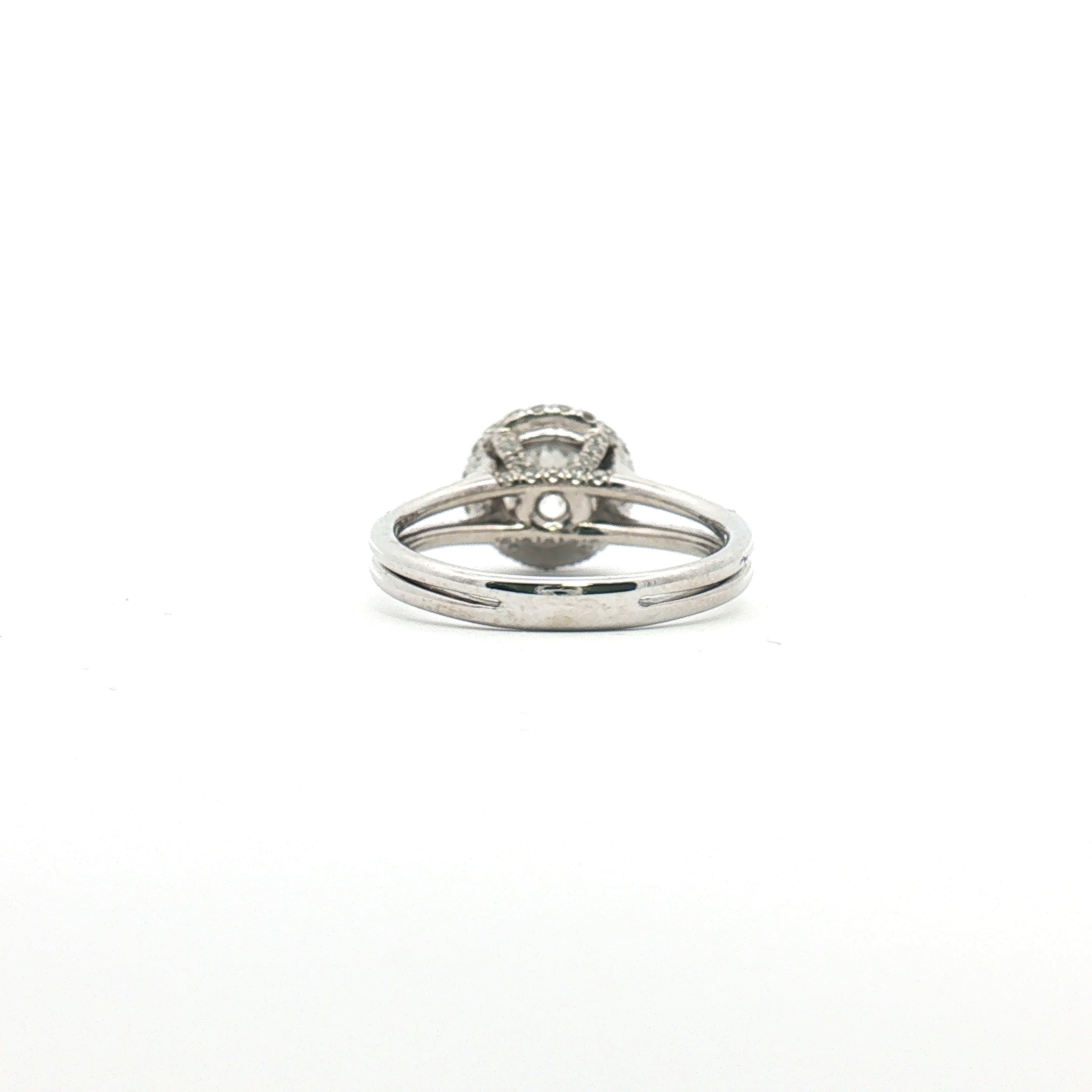 Platinum diamond halo ring with a central gemstone surrounded by smaller diamonds, crafted by Gold & Beyond.