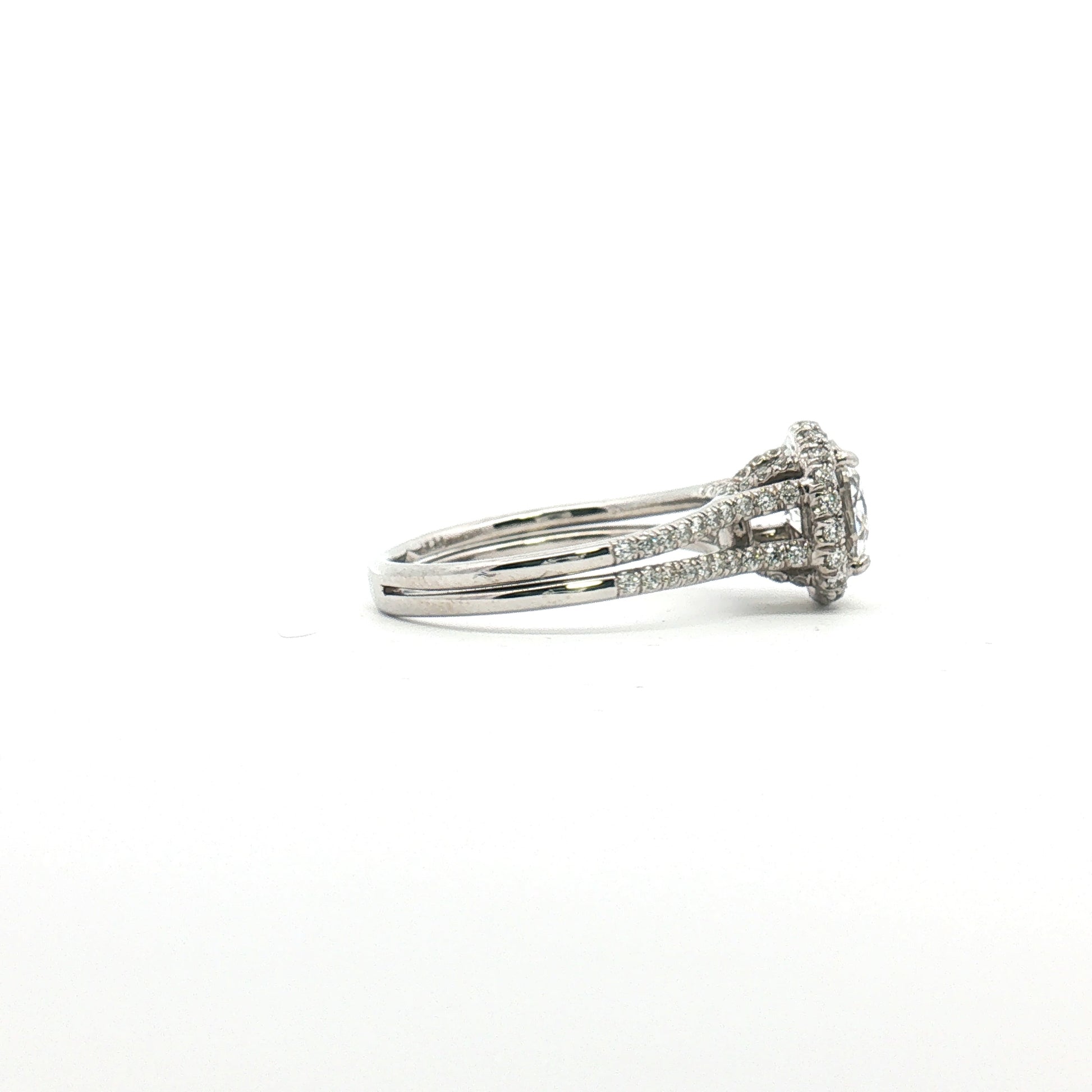 Platinum diamond halo ring with sparkling diamonds and intricate design, crafted by Gold & Beyond.