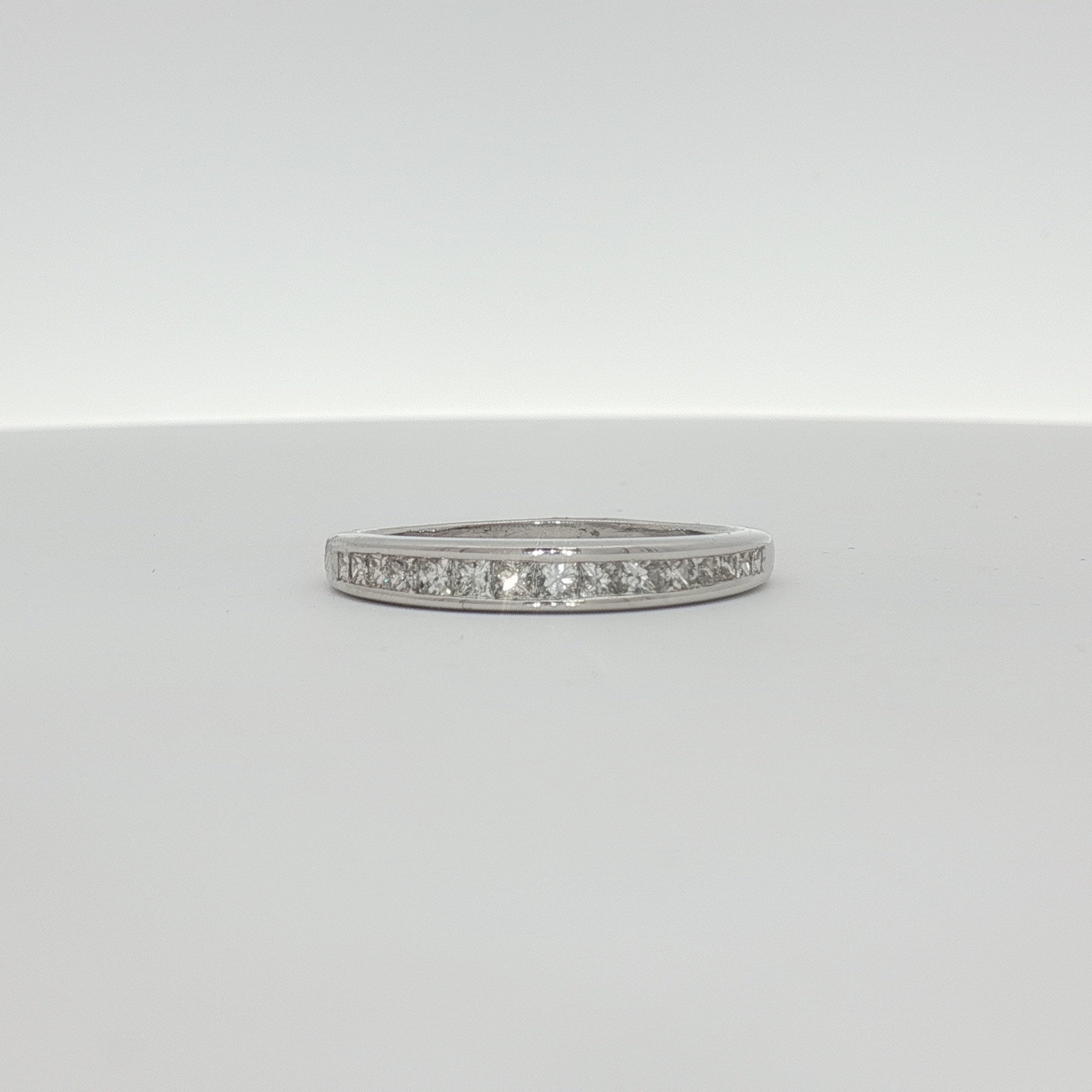 14K white gold diamond wedding band from Gold & Beyond featuring sparkling diamonds and a sleek, polished finish.