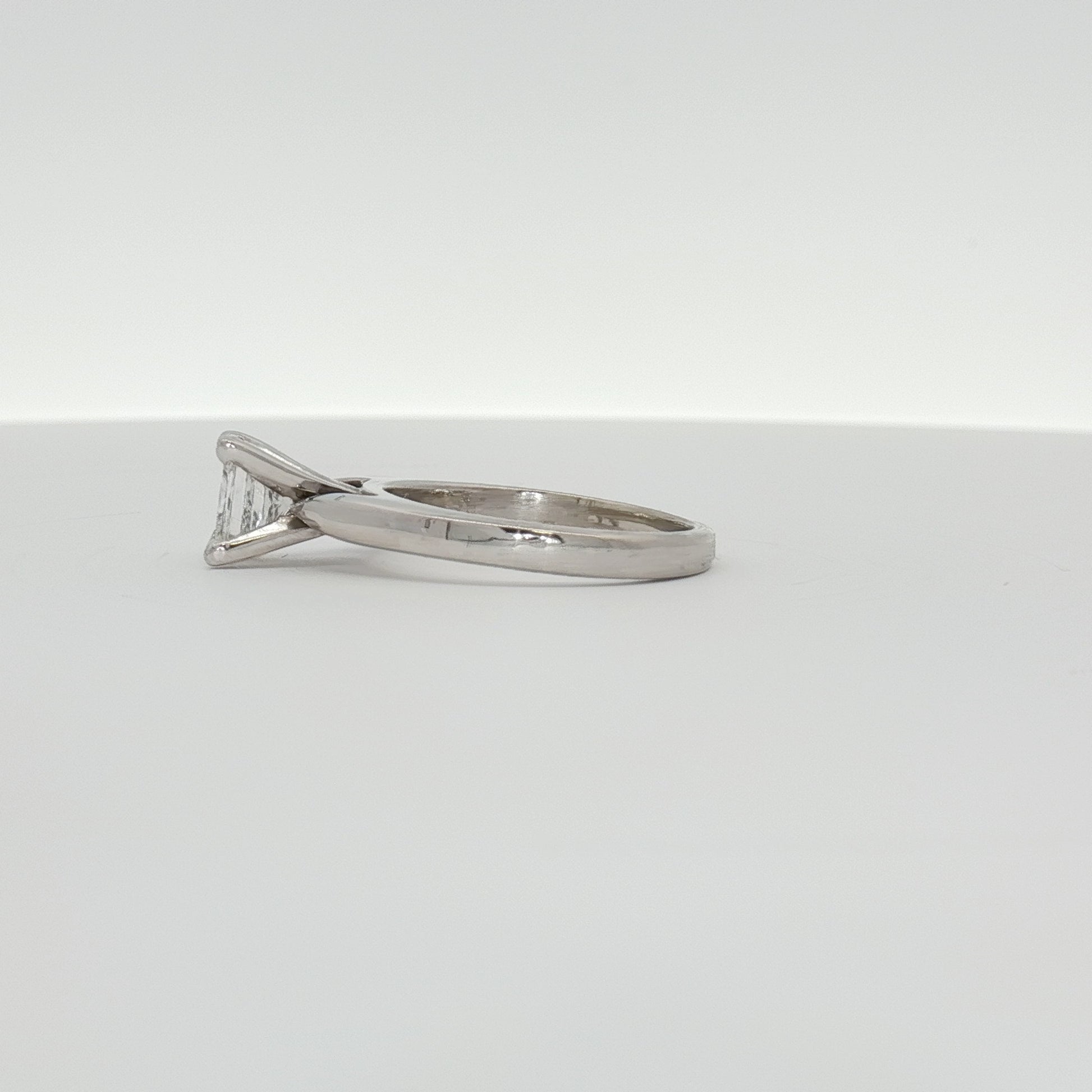 14K white gold diamond solitaire engagement ring with a central sparkling diamond and a sleek band, by Gold & Beyond.