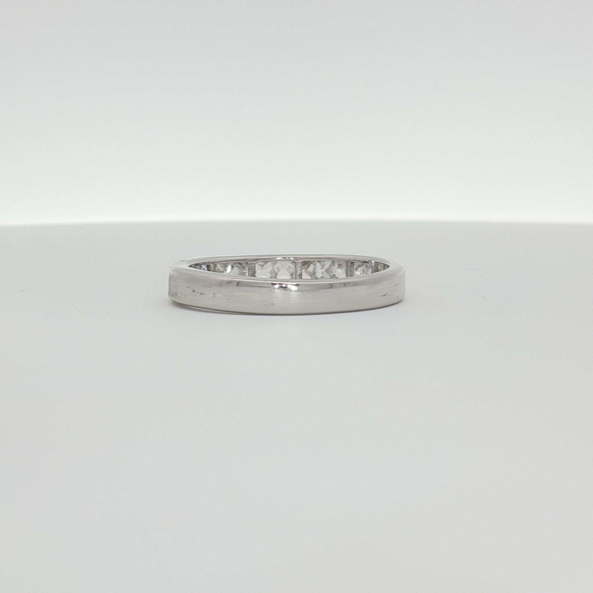 10K white gold diamond wedding band from Gold & Beyond, featuring a sleek design with sparkling diamonds.