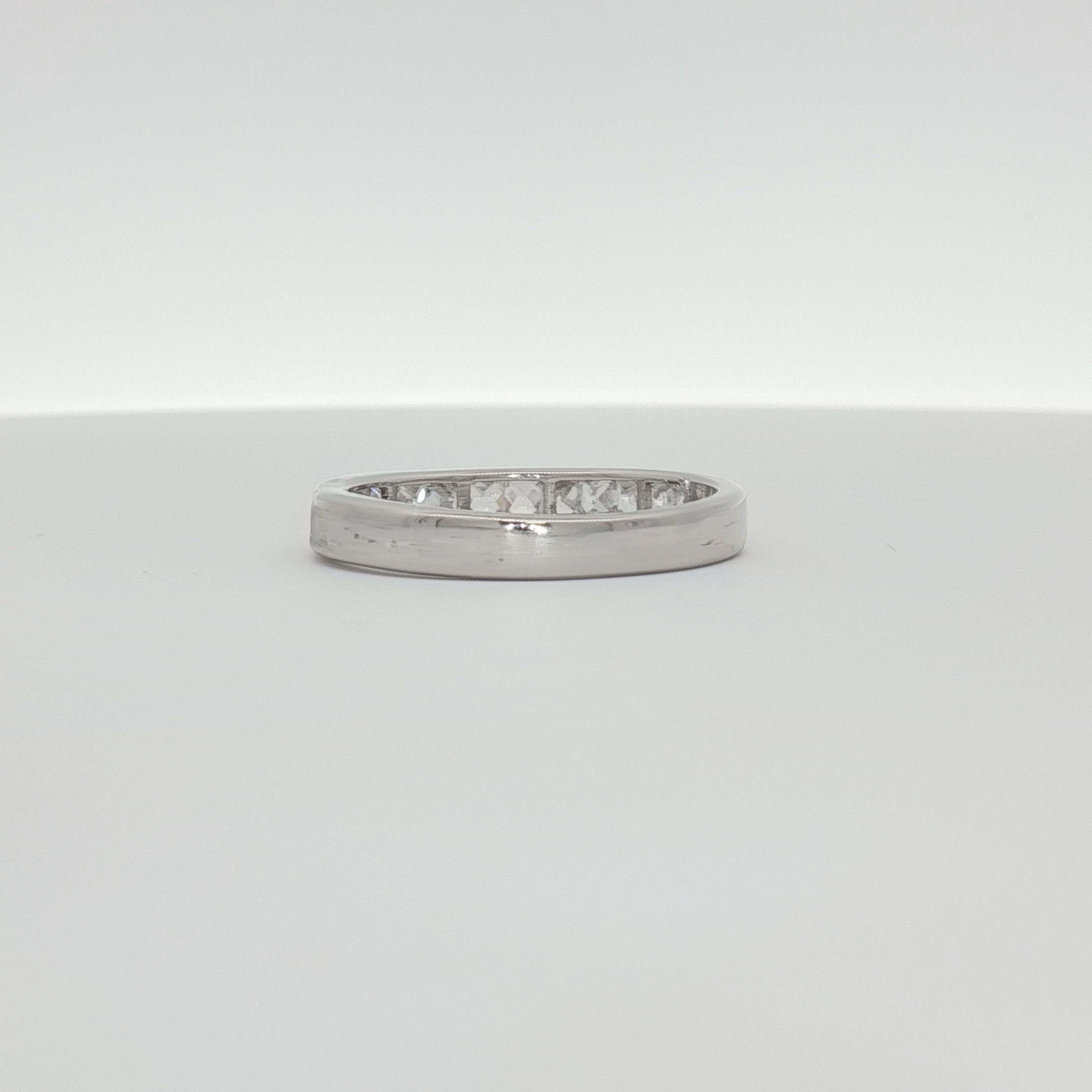 10K white gold diamond wedding band from Gold & Beyond, featuring a sleek design with sparkling diamonds.