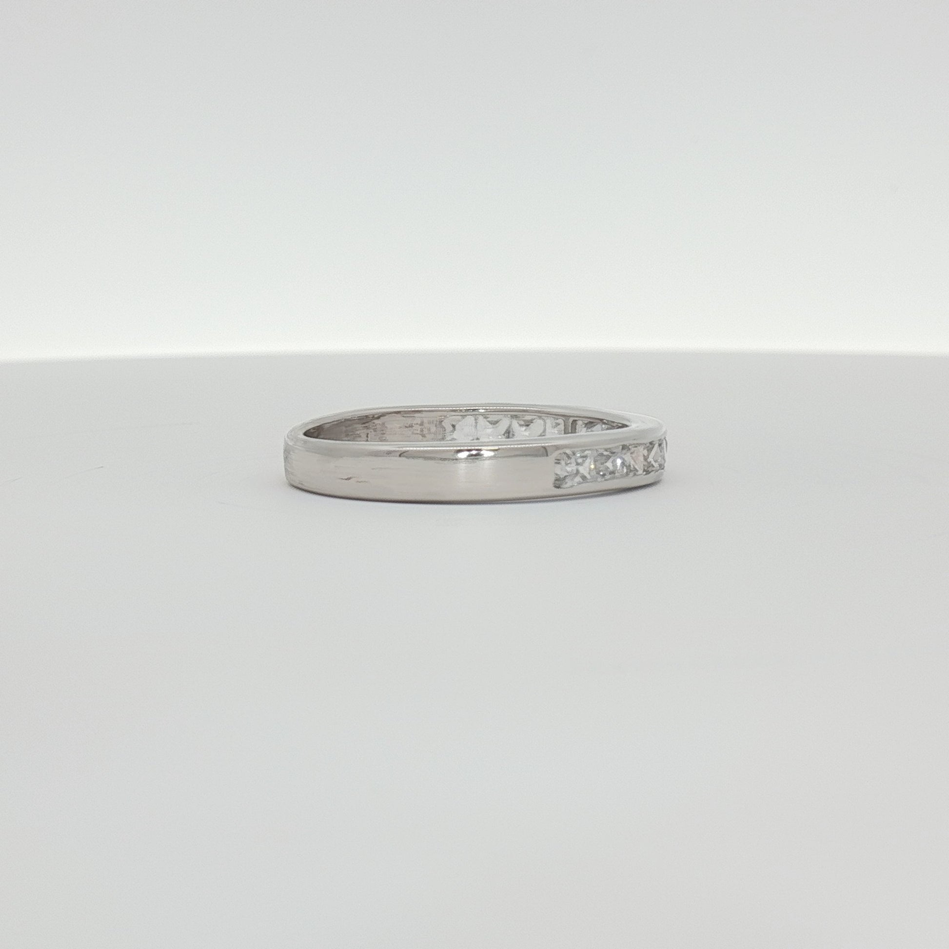 Elegant 10K white gold diamond wedding band featuring sparkling diamonds and a sleek design from Gold & Beyond jewelry collection.