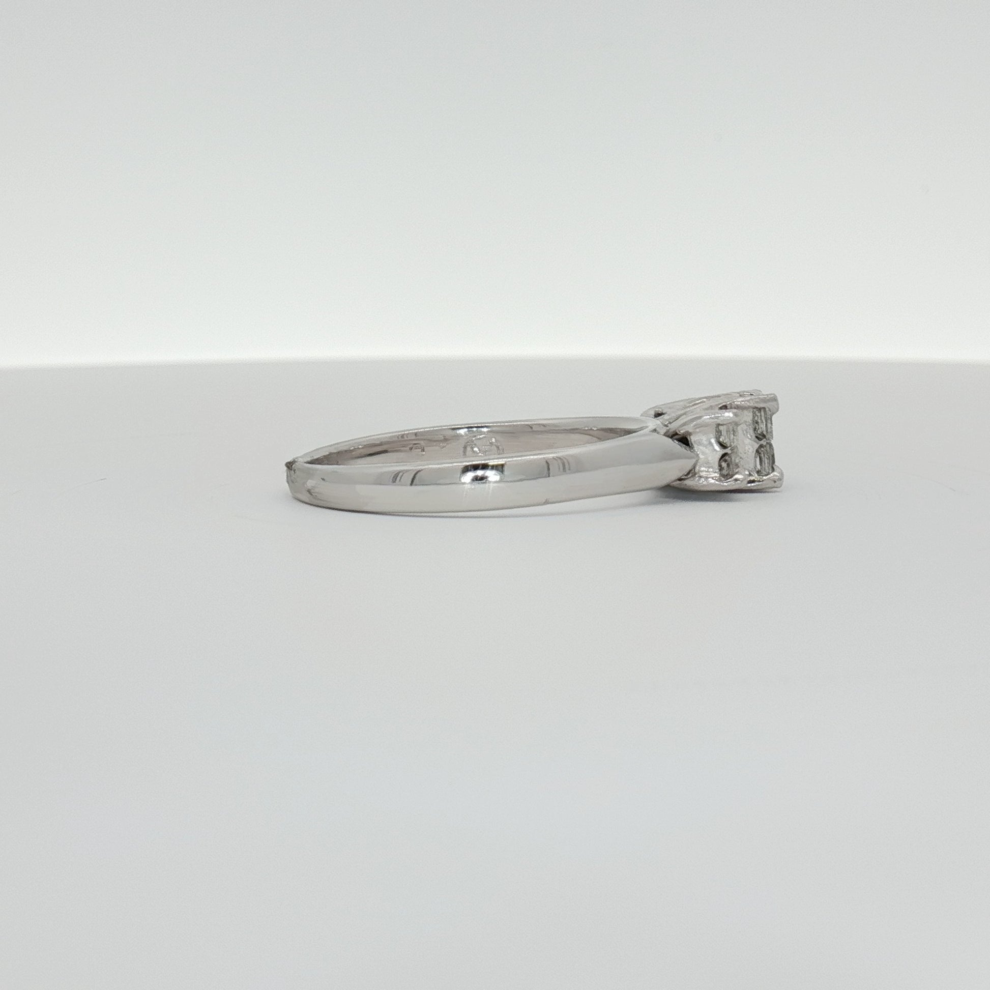 14K white gold diamond engagement ring with a central sparkling diamond and delicate band, crafted by Gold & Beyond.