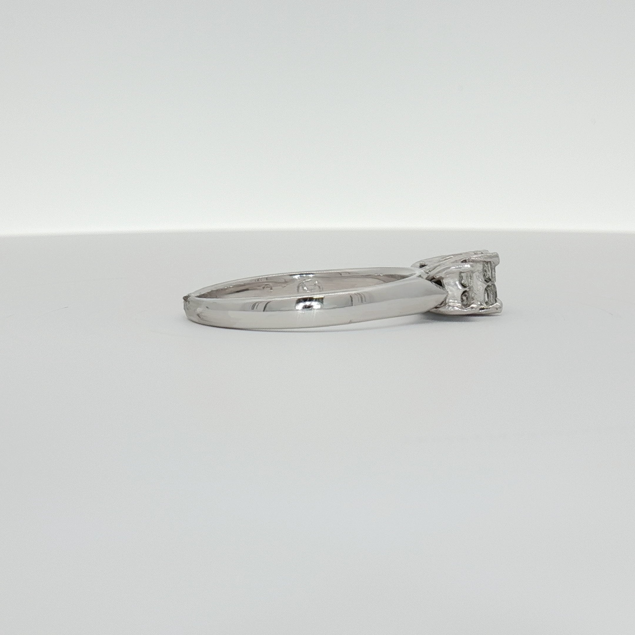 14K white gold diamond engagement ring with a central sparkling diamond and delicate band, crafted by Gold & Beyond.