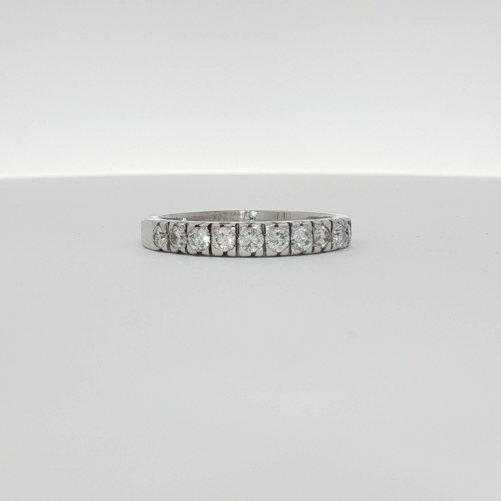 14K white gold diamond wedding band from Gold & Beyond with sparkling diamonds and smooth polished finish.