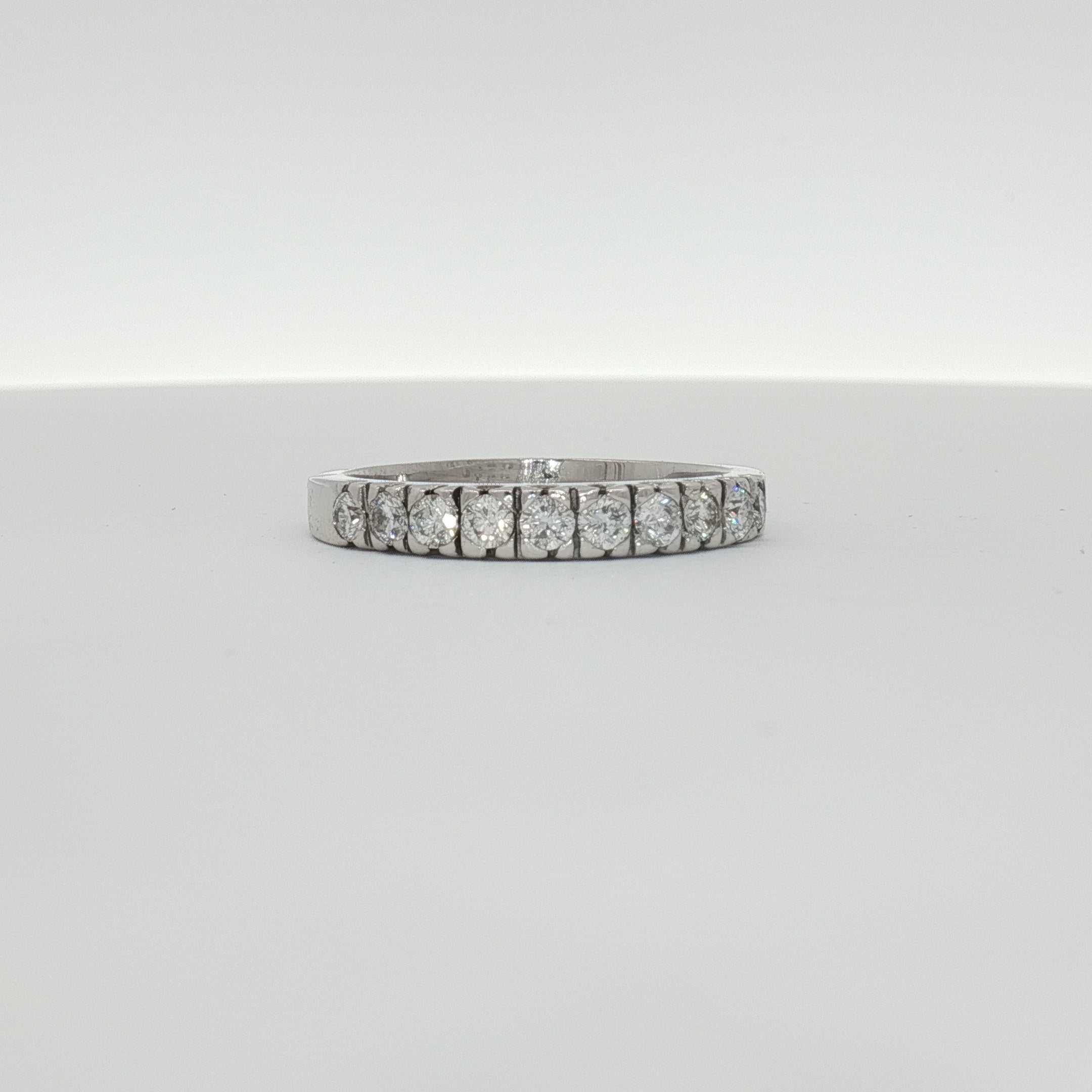 14K white gold diamond wedding band from Gold & Beyond featuring sparkling diamonds and a sleek, elegant design.