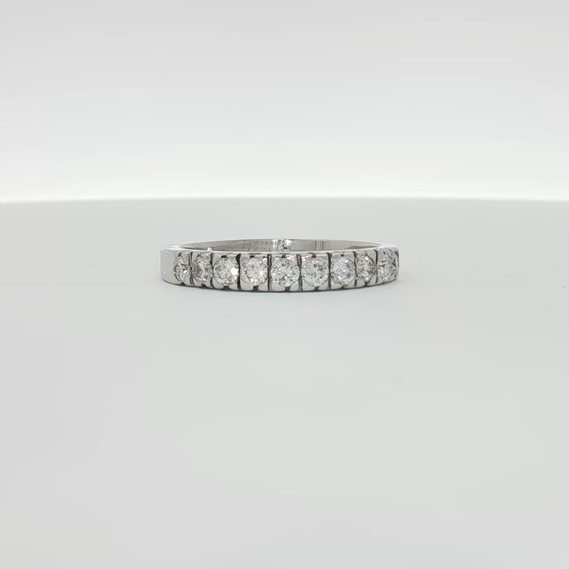 14K white gold diamond wedding band with sparkling diamonds, showcasing elegant jewelry design by Gold & Beyond.