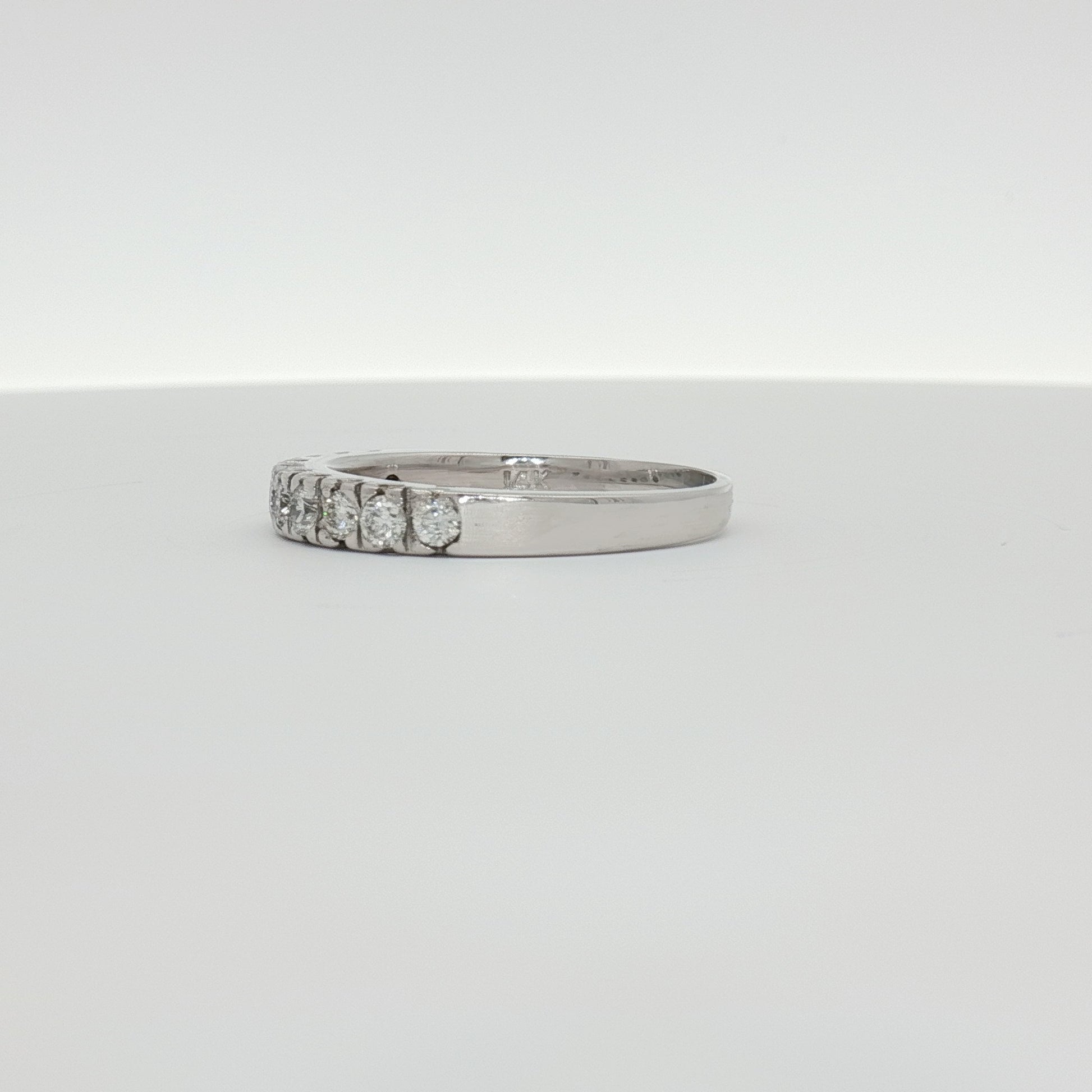 14K white gold diamond wedding band from Gold & Beyond, featuring sparkling diamonds and a sleek, polished finish.