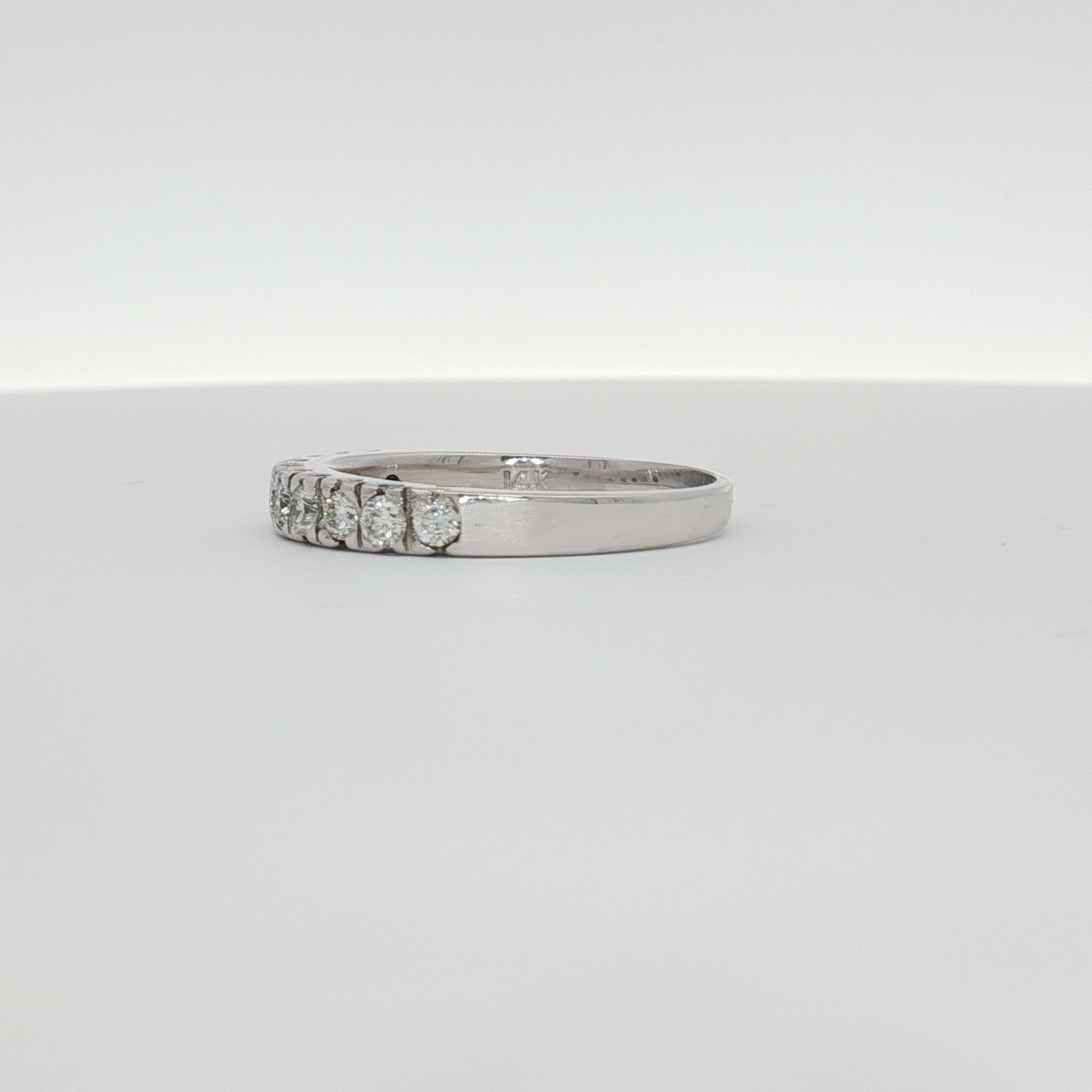 14K white gold diamond wedding band from Gold & Beyond, featuring sparkling diamonds and a sleek, polished finish.