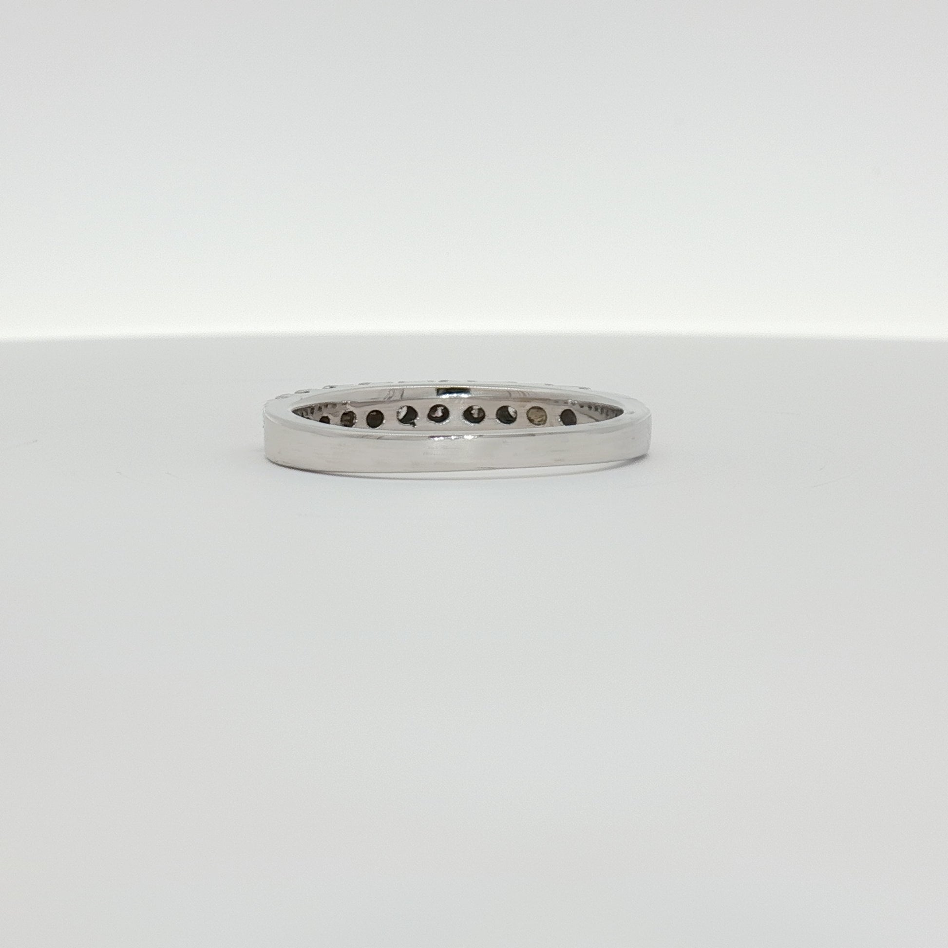 14K white gold diamond wedding band with sparkling diamonds, showcasing elegant jewelry design by Gold & Beyond.