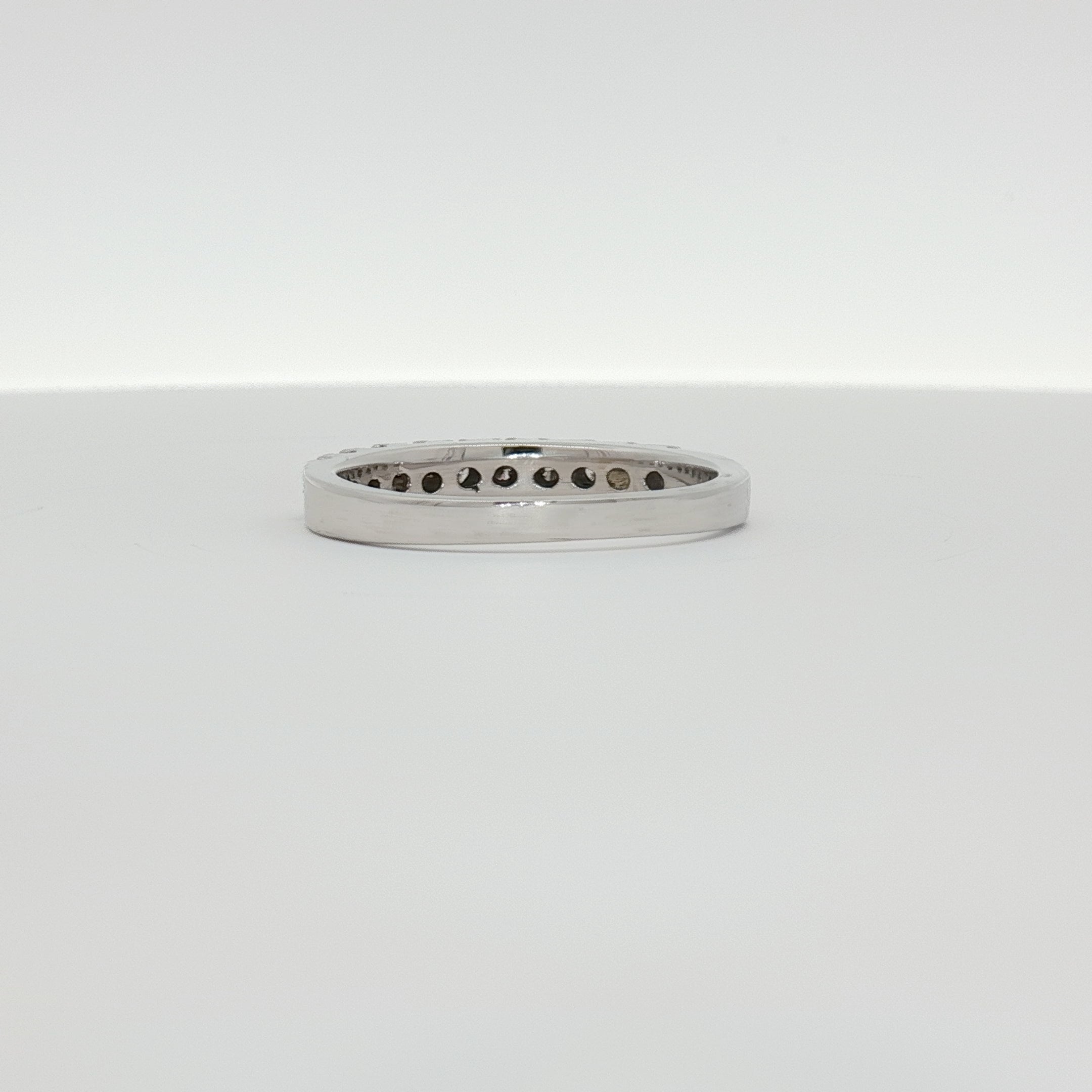 14K white gold diamond wedding band with sparkling diamonds, showcasing elegant jewelry design by Gold & Beyond.