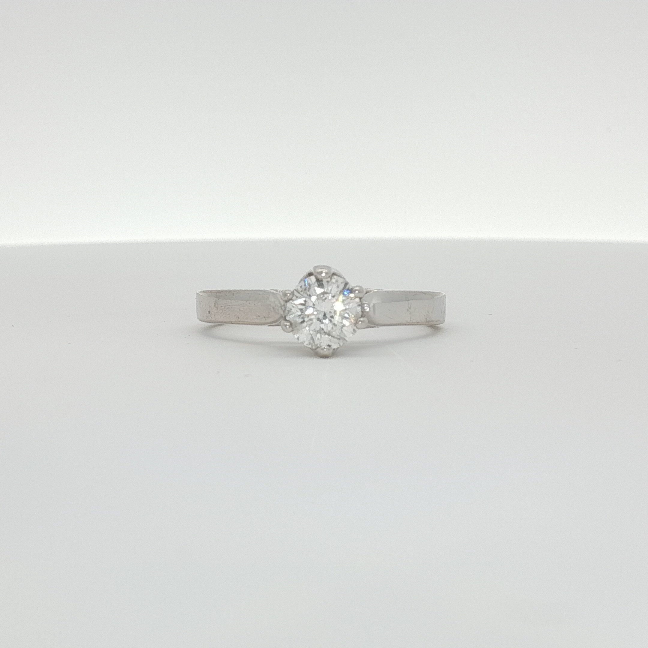 10K white gold diamond solitaire ring featuring a sparkling central diamond and a sleek band, crafted by Gold & Beyond.