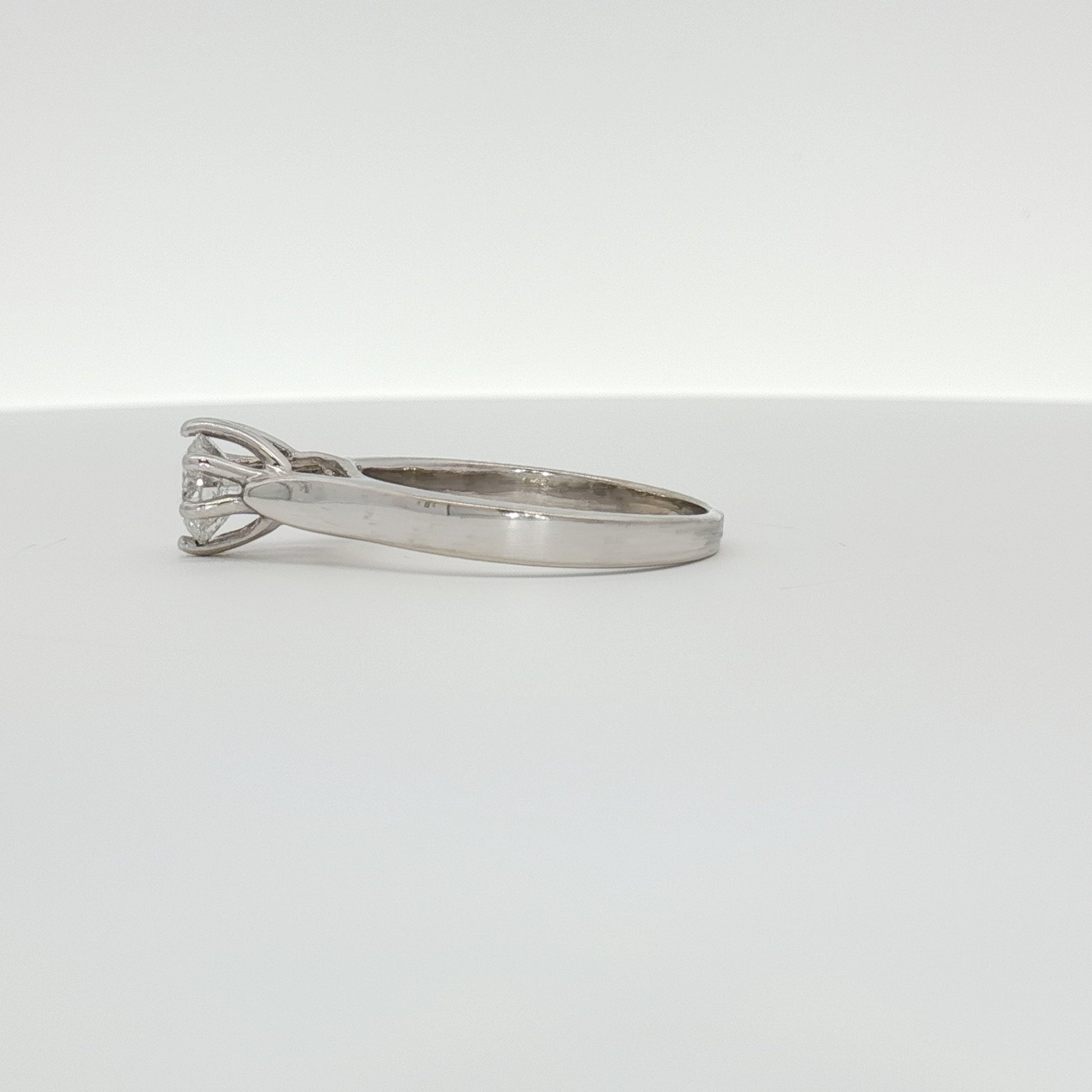 Elegant 10K white gold diamond solitaire ring by Gold & Beyond showcasing a sparkling central diamond on a sleek band