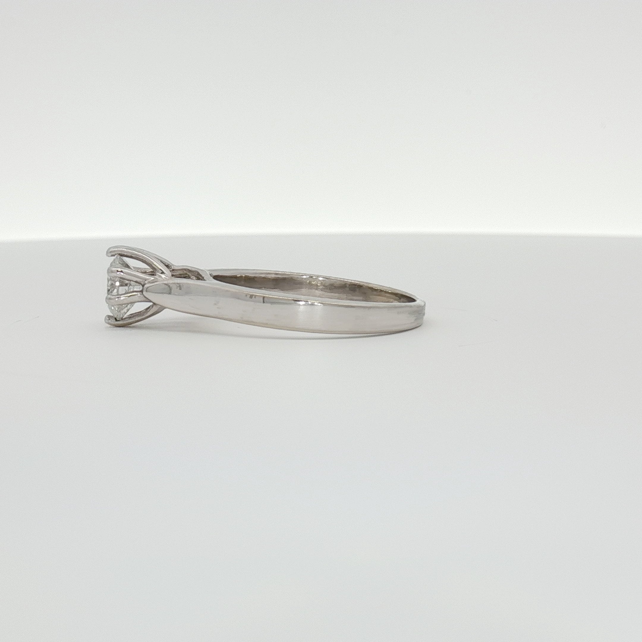 Elegant 10K white gold diamond solitaire ring by Gold & Beyond showcasing a sparkling central diamond on a sleek band