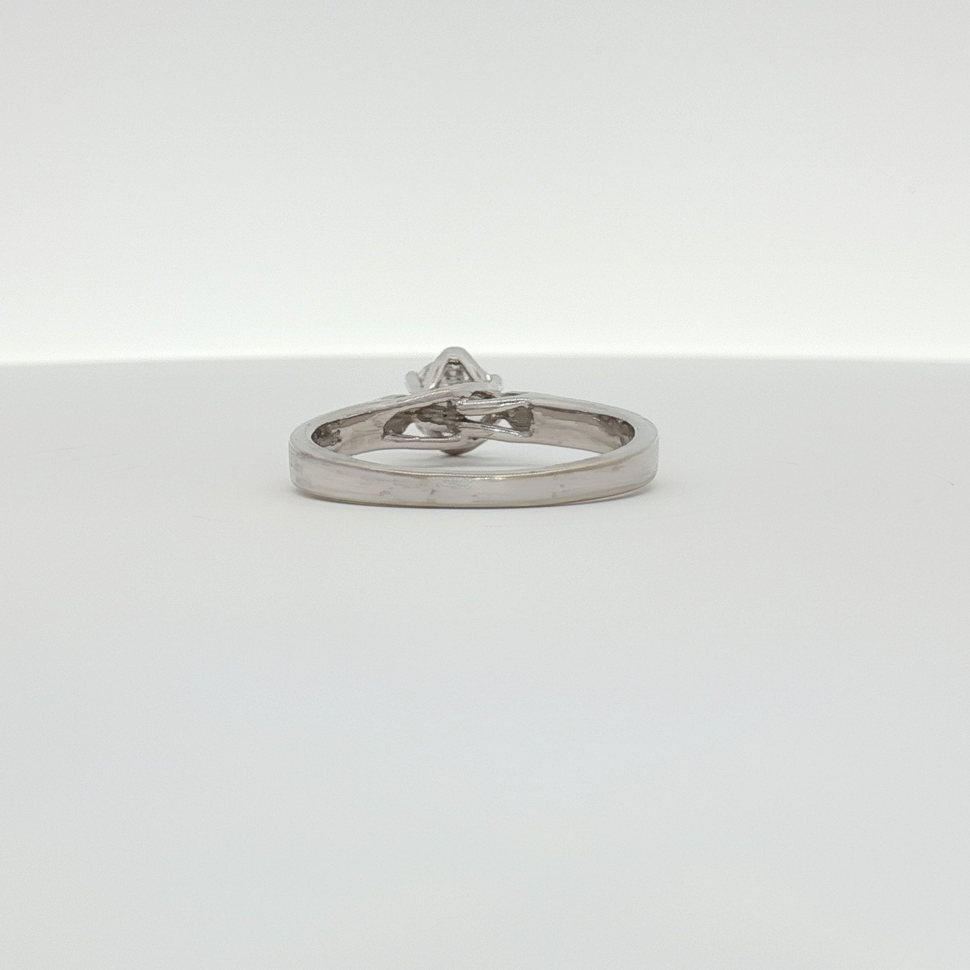 10K white gold diamond solitaire ring from Gold & Beyond featuring a sparkling central diamond and sleek band design.