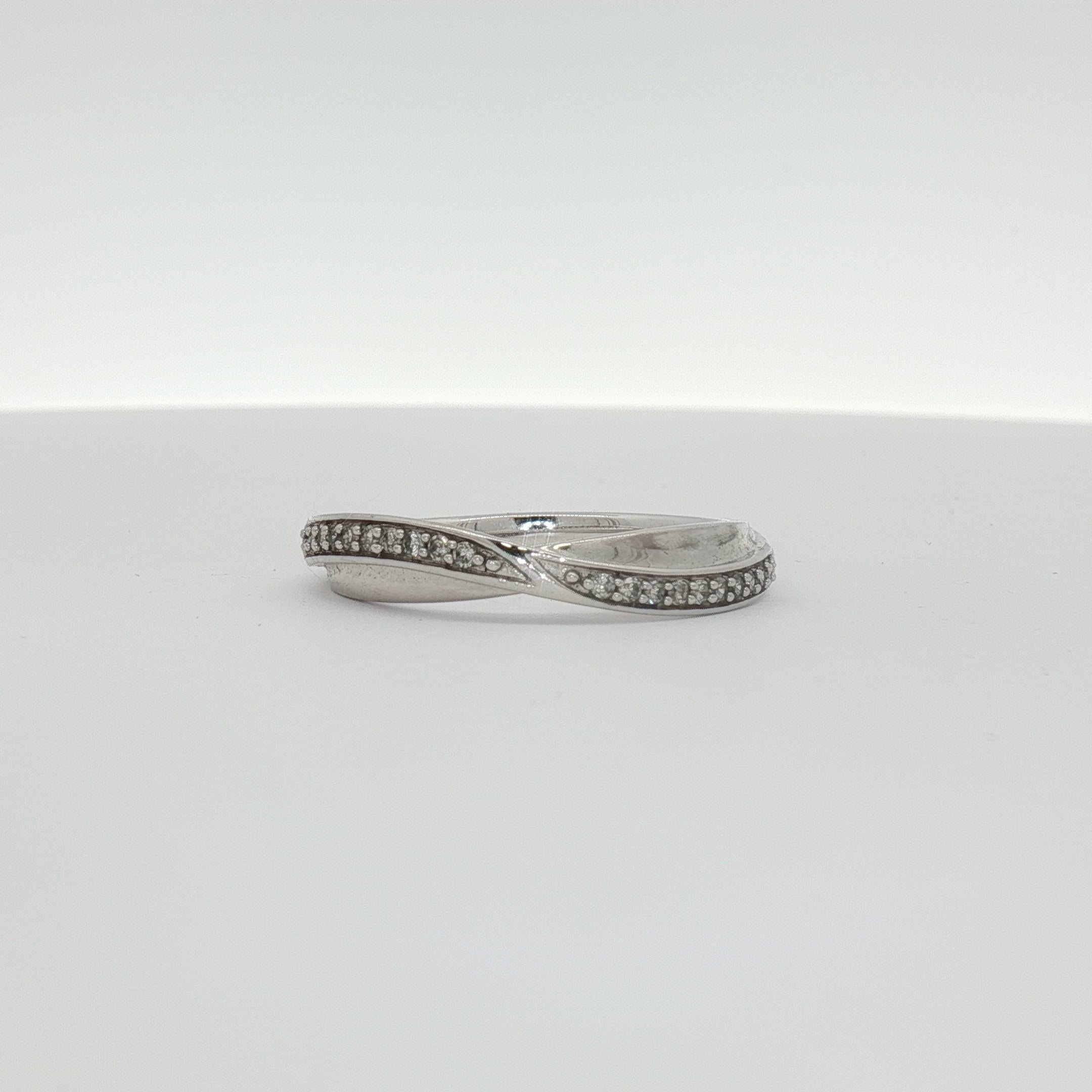 10K white gold diamond twist band ring showcasing sparkling diamonds and elegant design from Gold & Beyond jewelry collection.