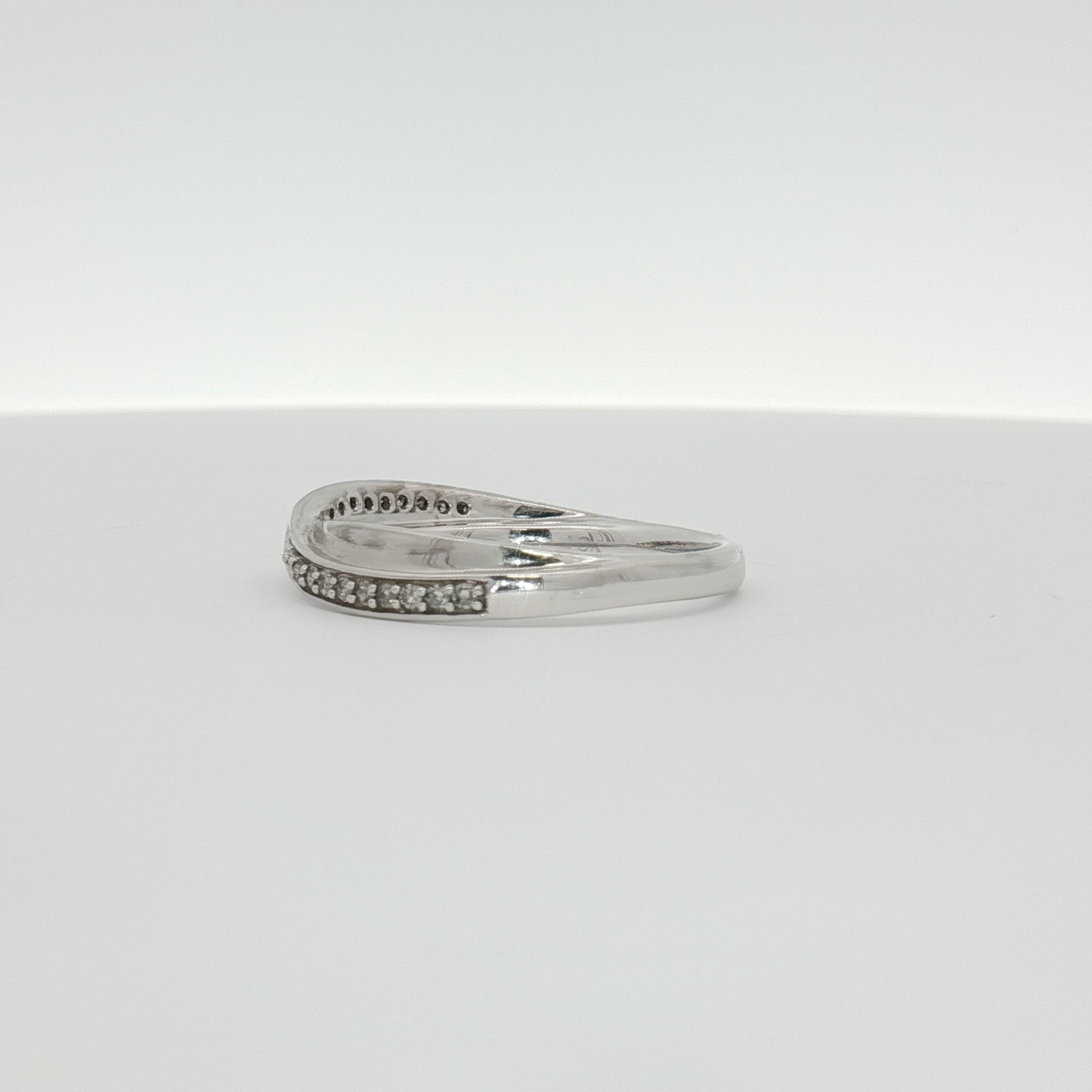 10K white gold diamond twist band ring with sparkling diamonds, elegant jewelry piece from Gold & Beyond.
