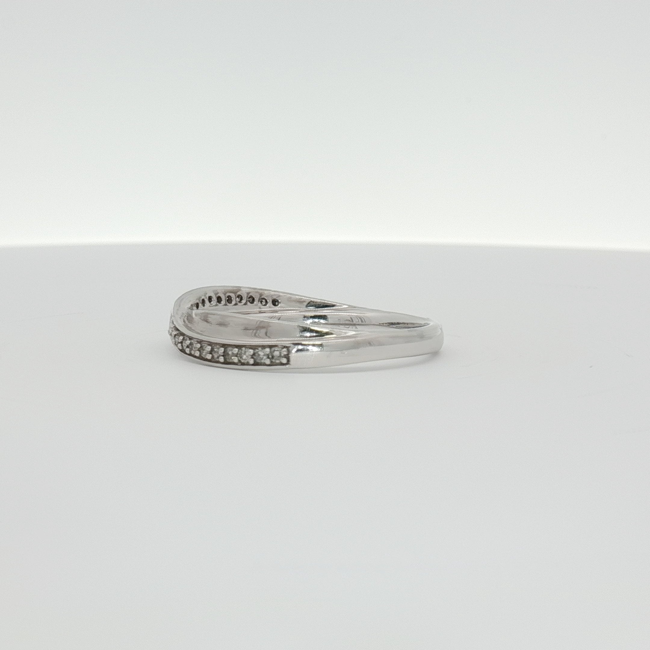 10K white gold diamond twist band ring with sparkling diamonds, elegant jewelry piece from Gold & Beyond.