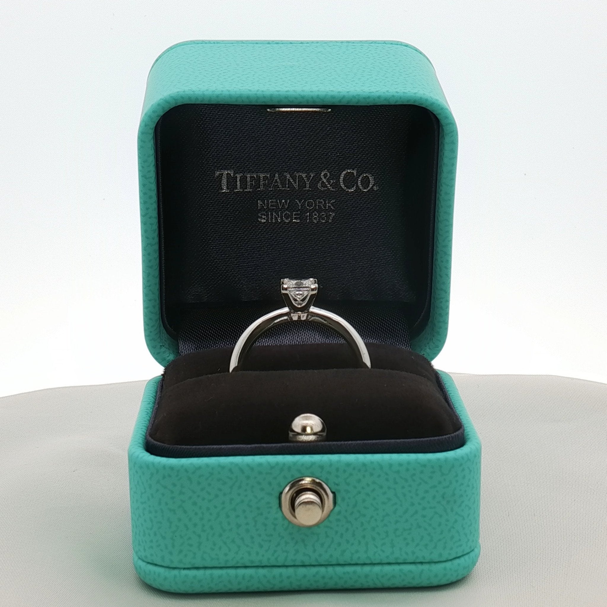 Platinum diamond solitaire ring from Tiffany & Co. featuring a single sparkling diamond set in elegant jewelry style.