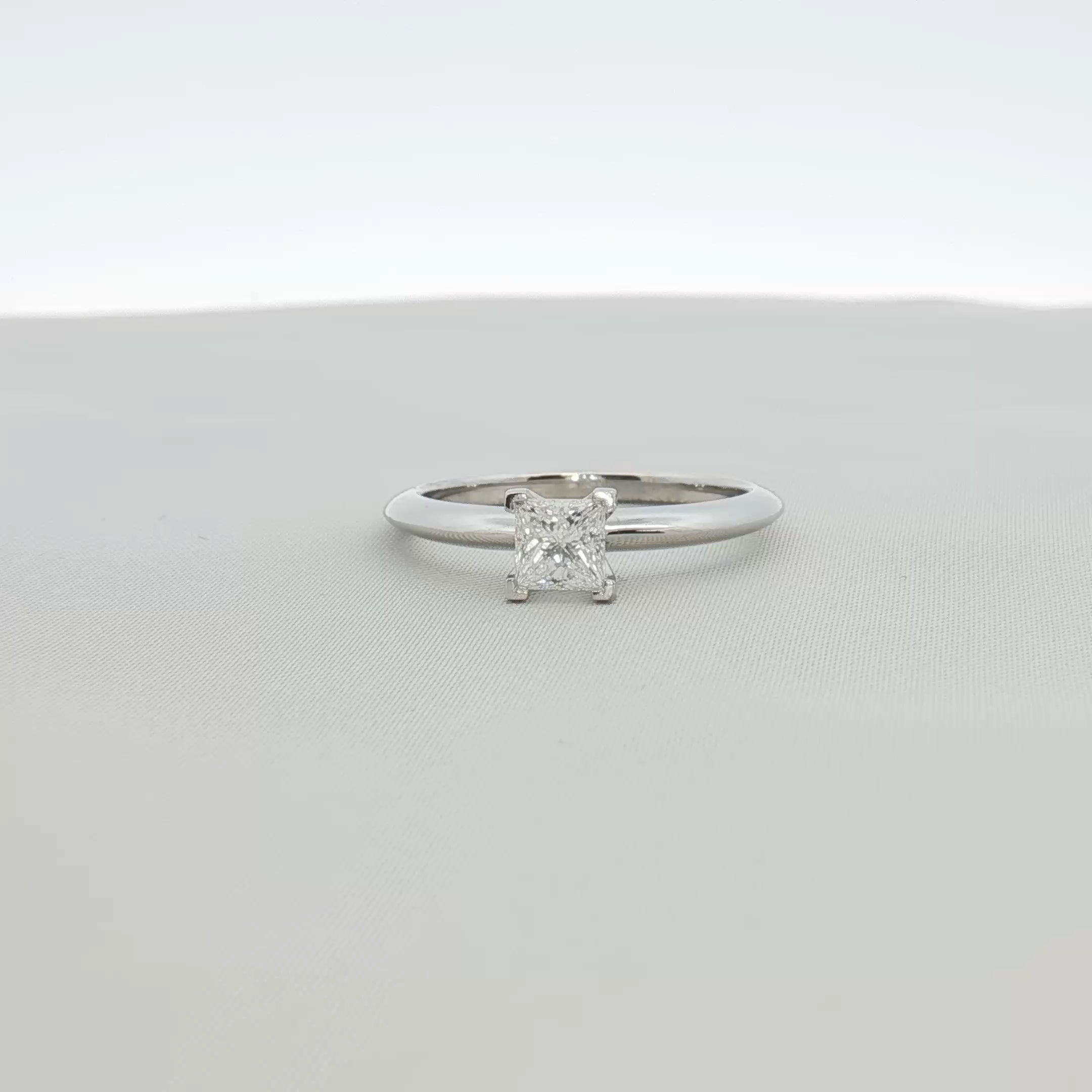 Tiffany & Co. platinum diamond solitaire ring showcasing a sparkling diamond set on a sleek platinum band.