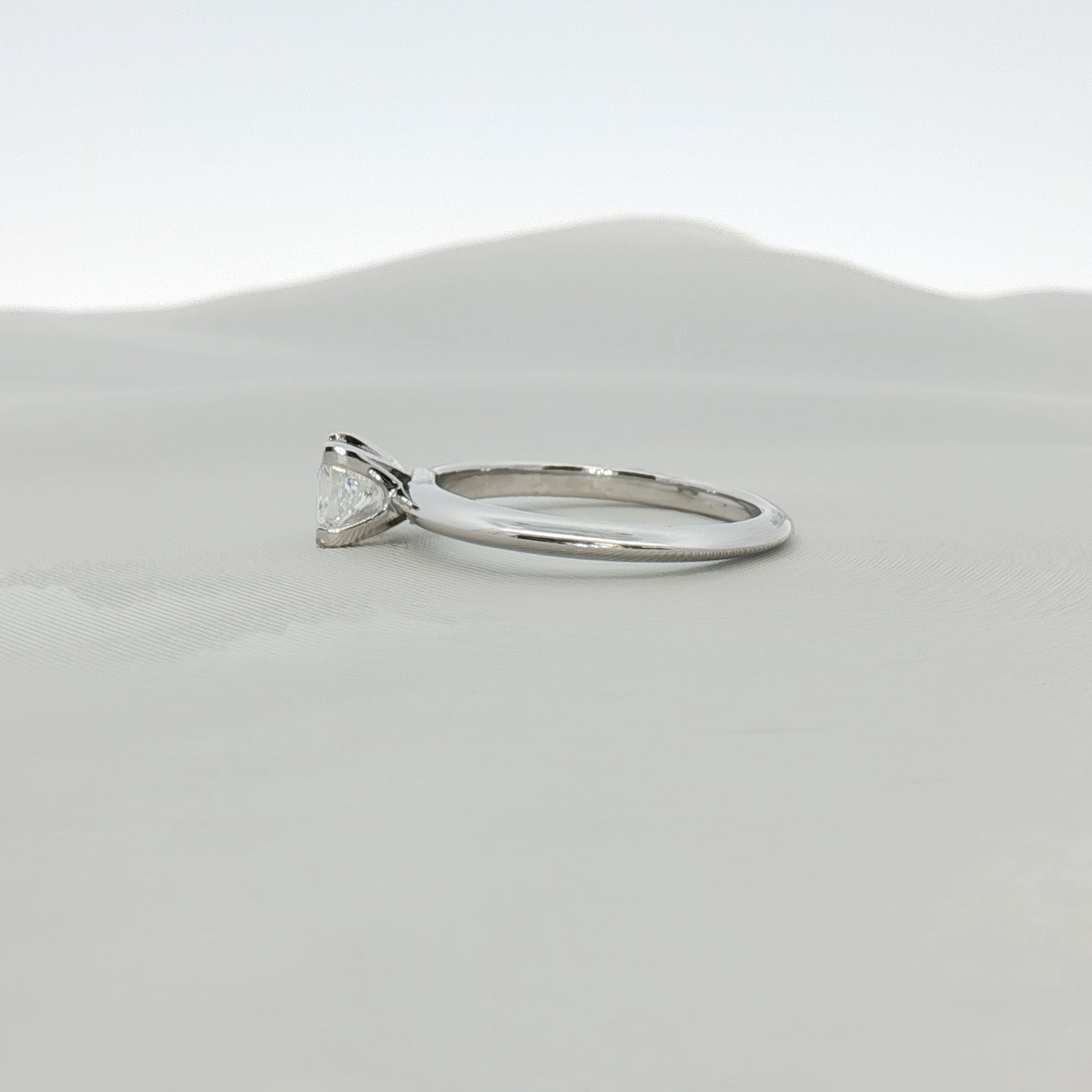 Platinum diamond solitaire ring by Gold & Beyond, featuring a sparkling diamond set in a sleek platinum band.