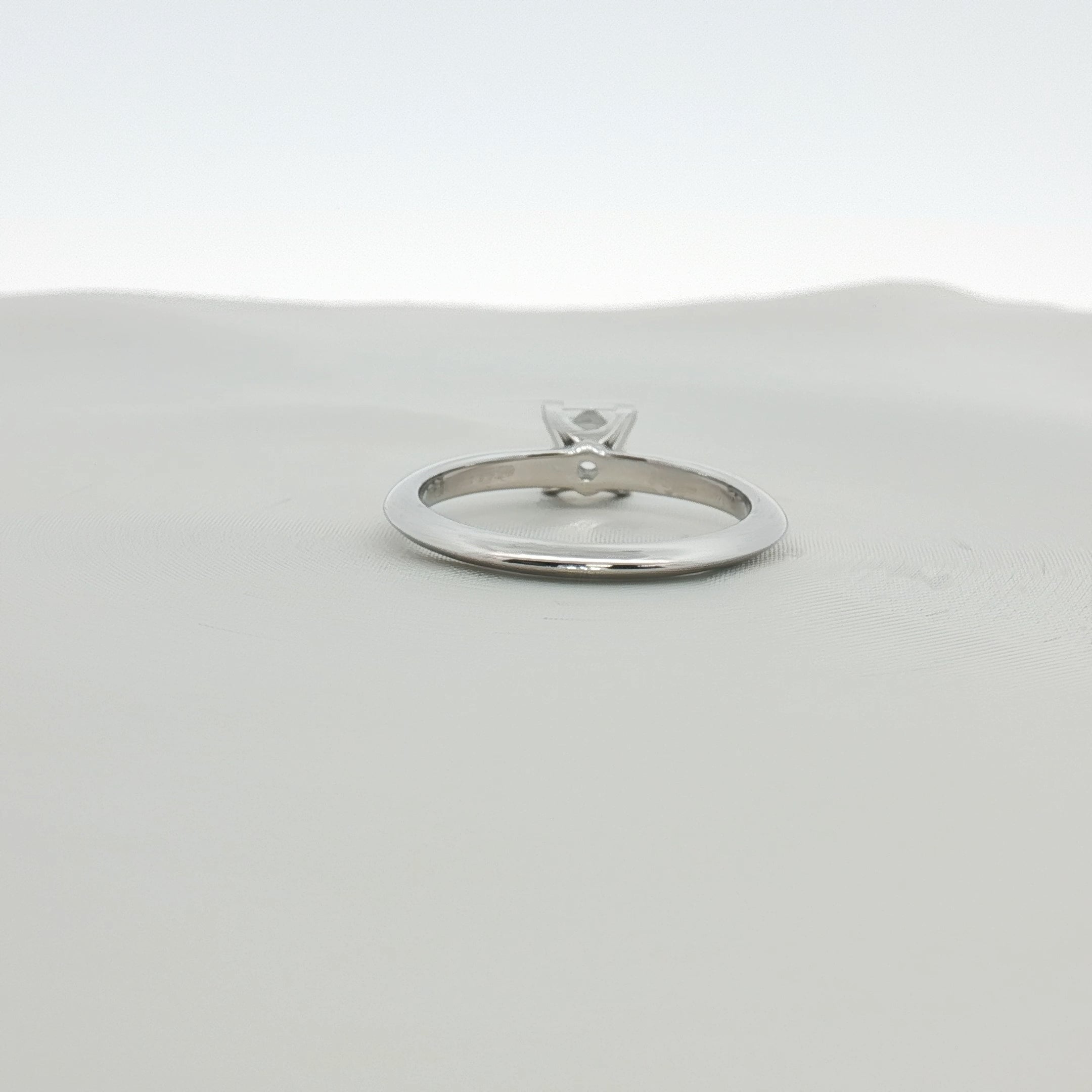 Platinum diamond solitaire ring from Tiffany & Co. featuring a prominent central diamond set on a sleek band.