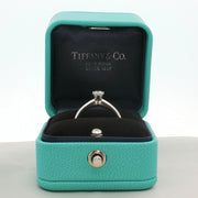 Tiffany & Co. platinum diamond solitaire ring, showcasing a single sparkling diamond set on a sleek platinum band.