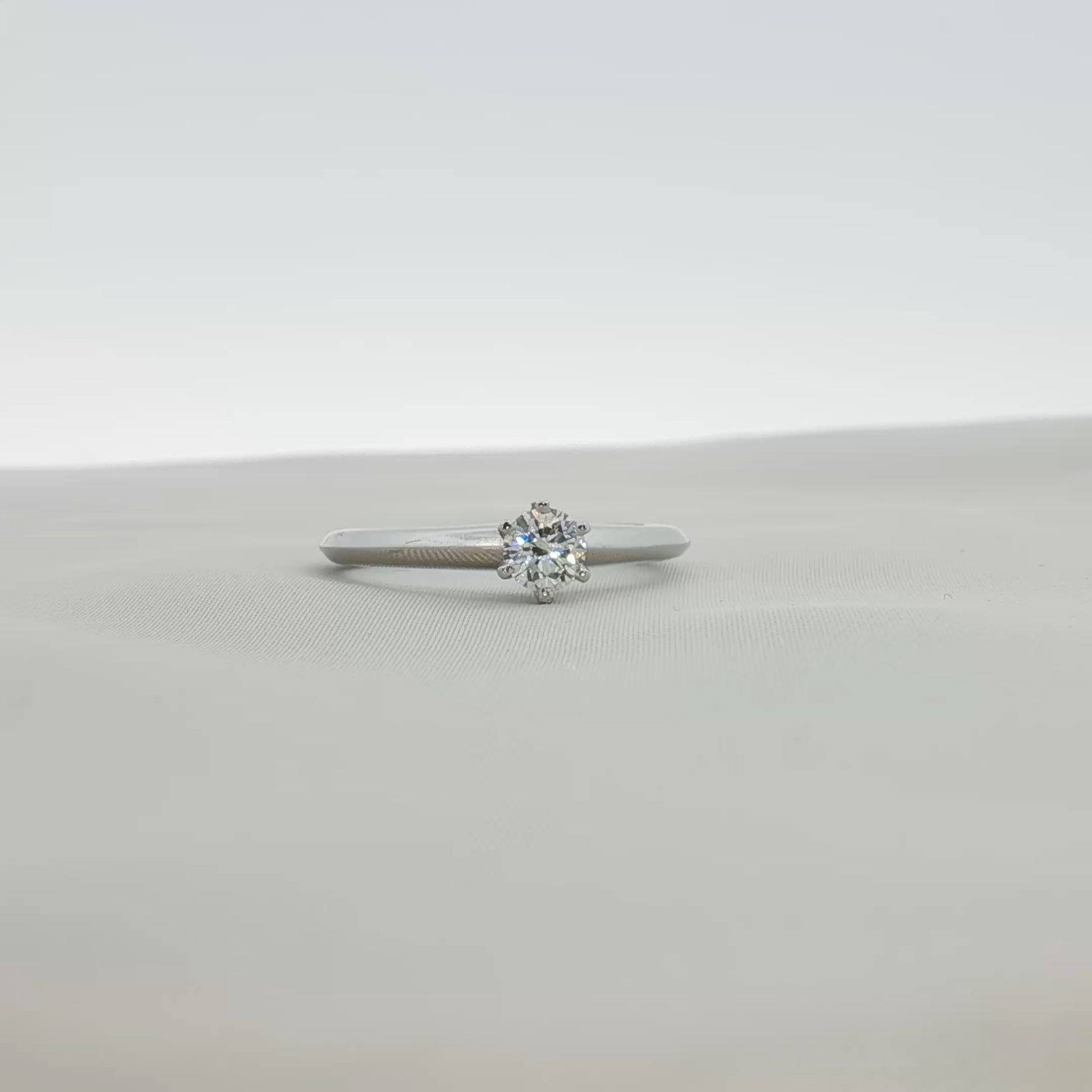 Platinum diamond solitaire ring from Tiffany & Co., featuring a single sparkling diamond set in a sleek band.