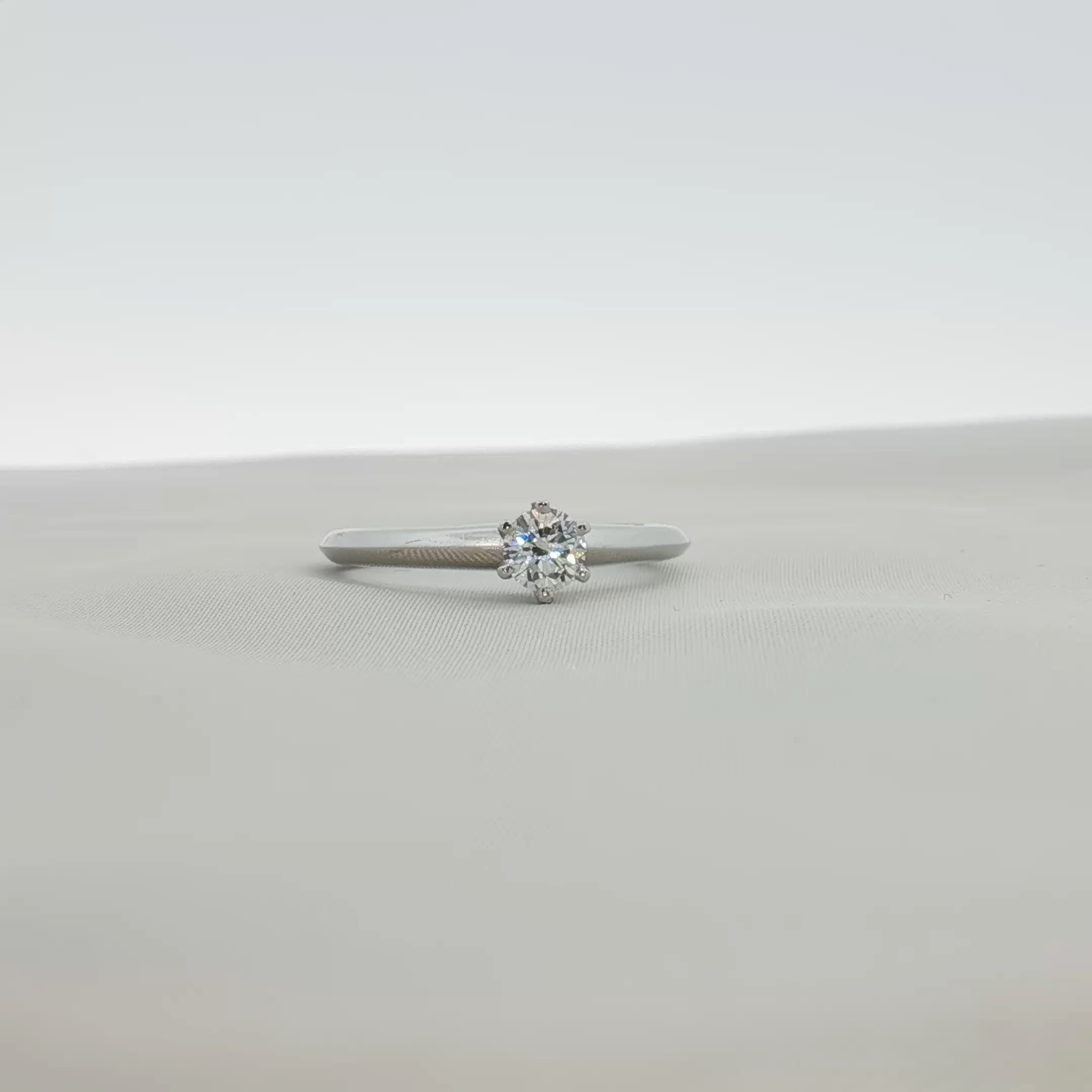 Platinum diamond solitaire ring from Tiffany & Co., featuring a single sparkling diamond set in a sleek band.