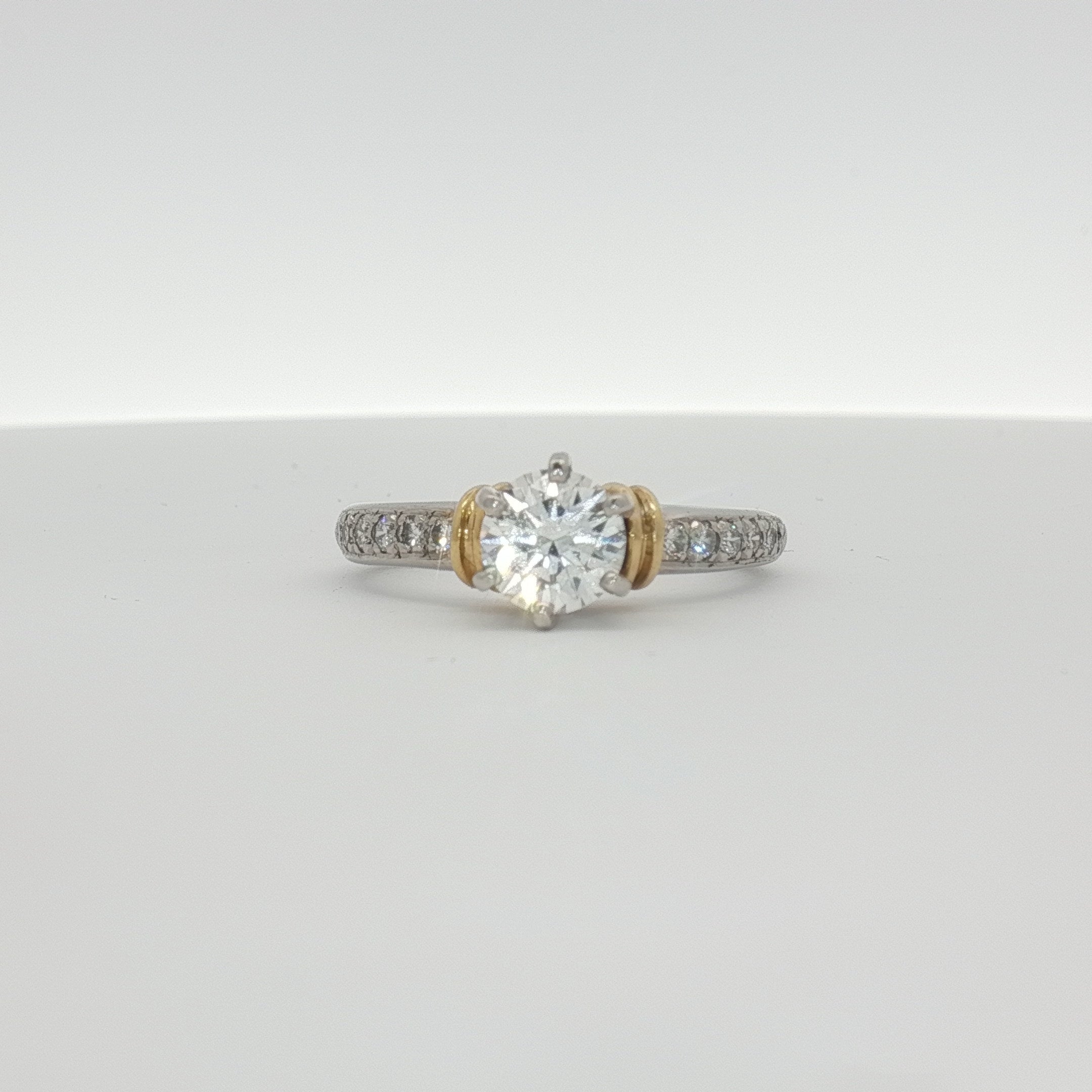 Platinum diamond engagement ring from Gold & Beyond featuring a central sparkling diamond set in elegant jewelry design.