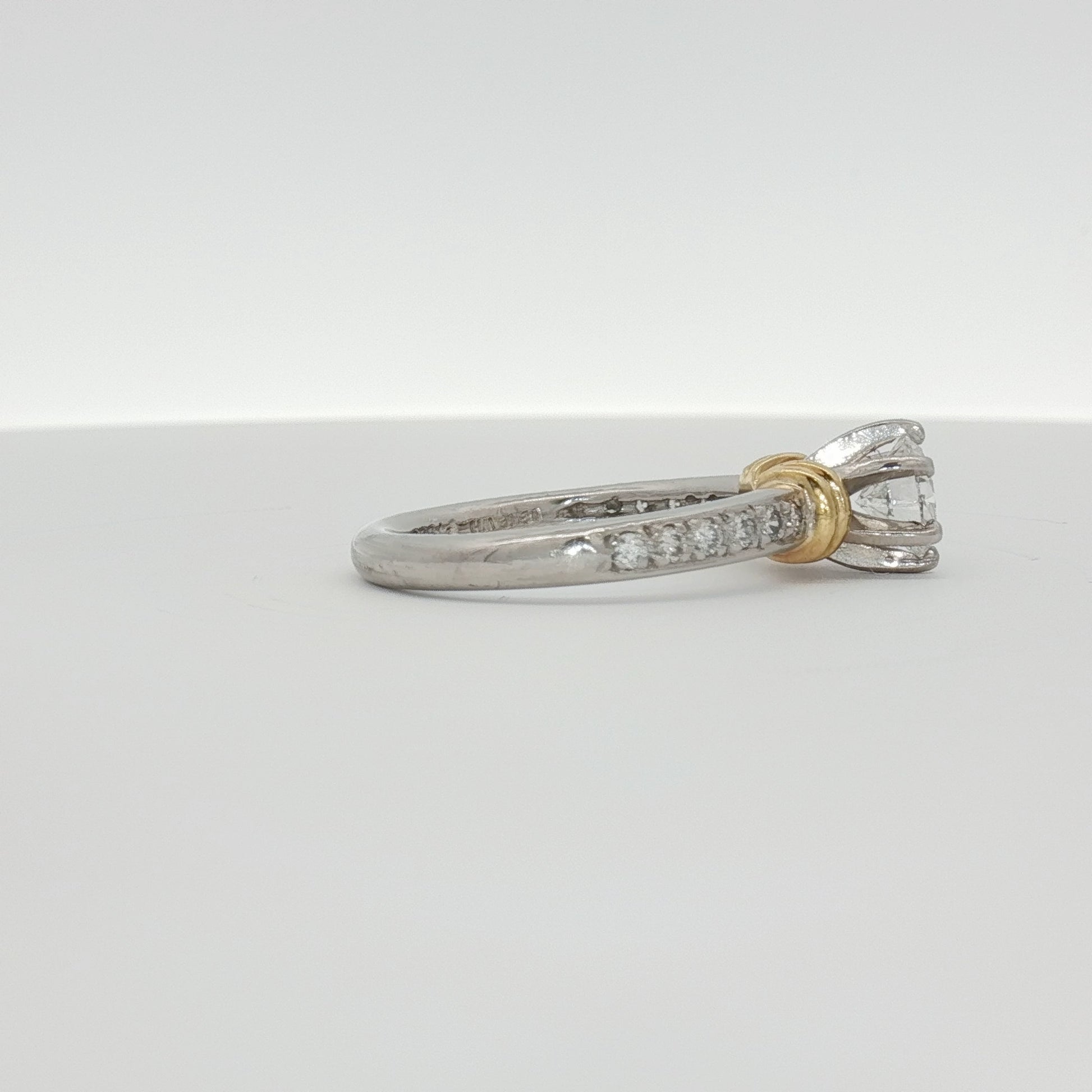Platinum diamond engagement ring with a central sparkling diamond set in a sleek platinum band, crafted by Gold & Beyond.