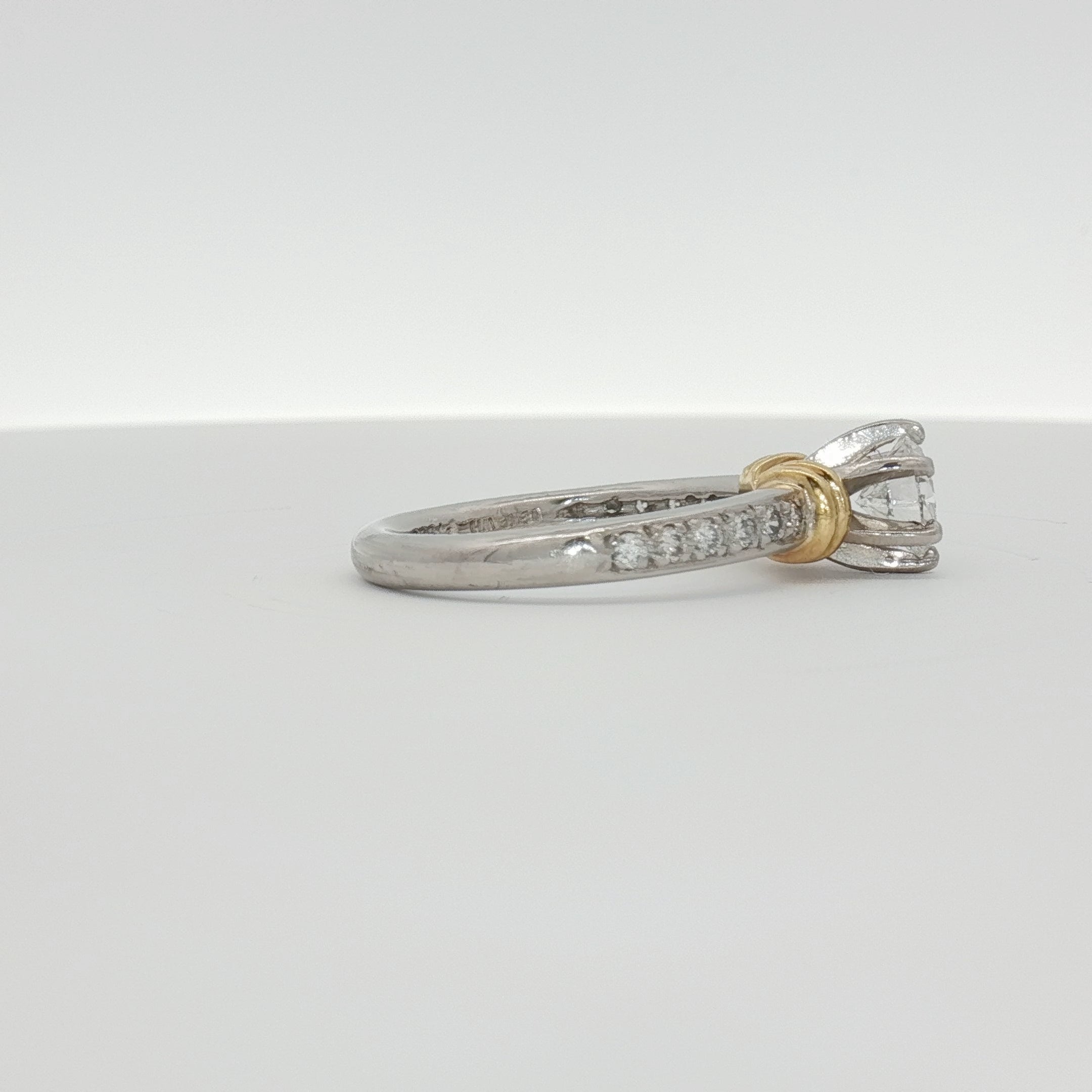 Platinum diamond engagement ring with a central sparkling diamond set in a sleek platinum band, crafted by Gold & Beyond.
